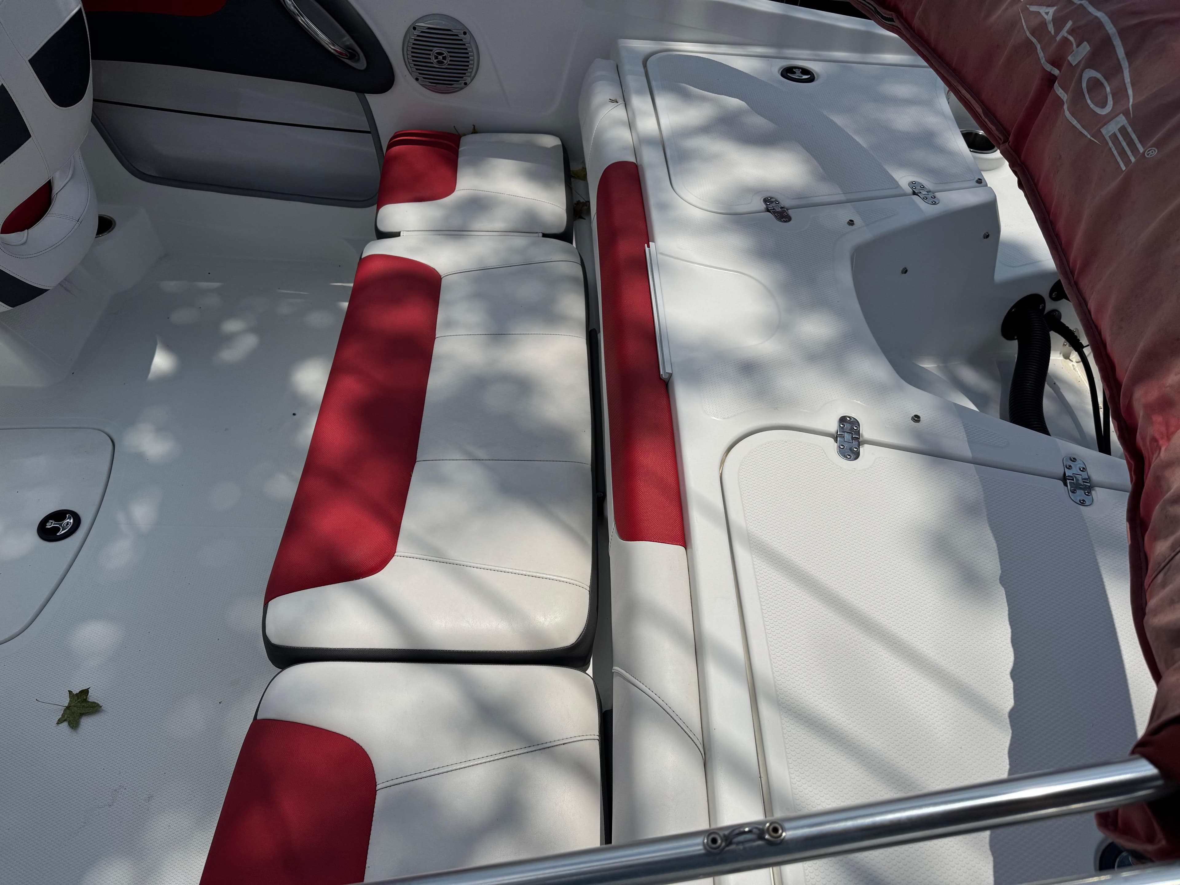 Interior of a 2020 Tahoe 550TS boat with red and white seating.