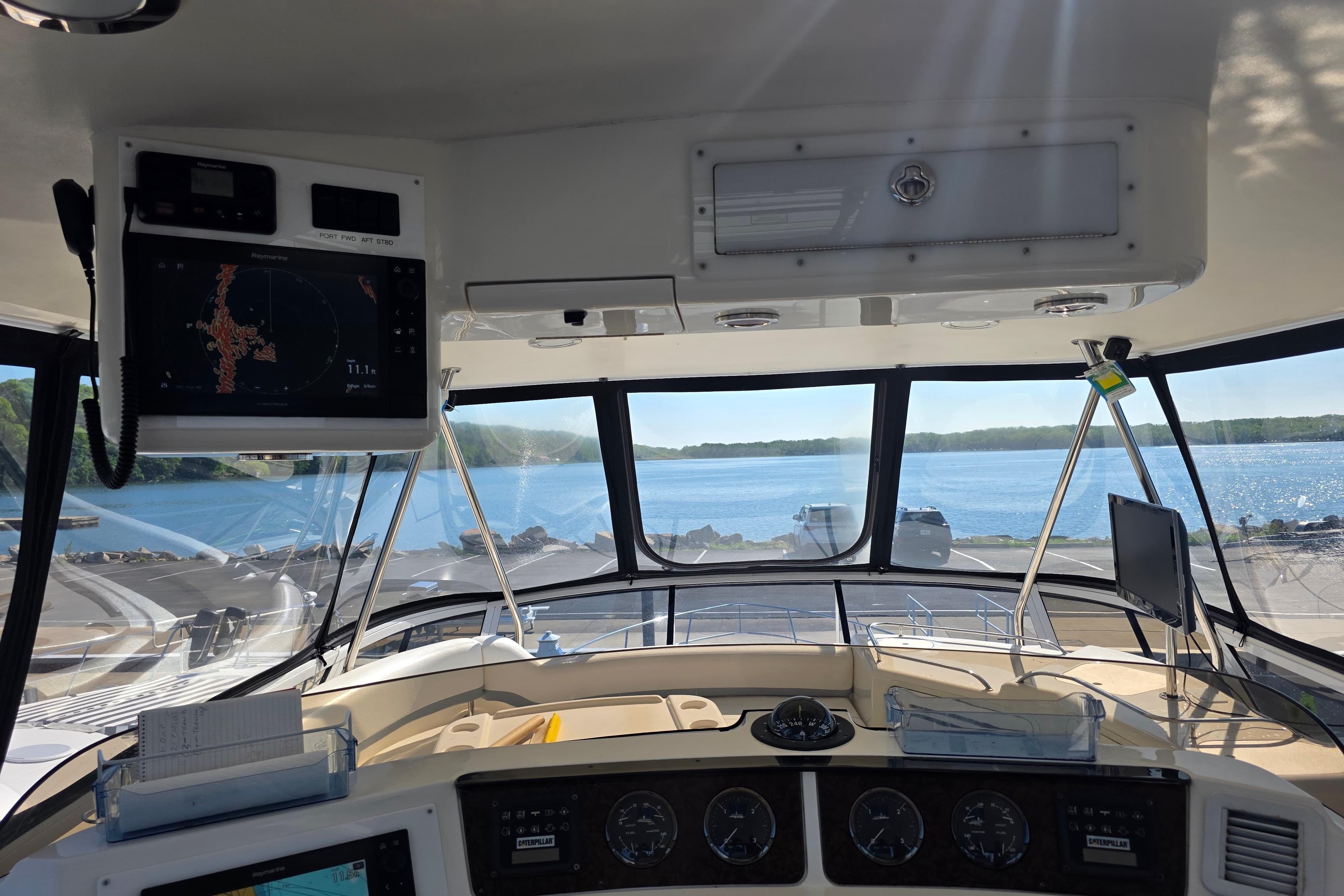 Interior view of 2002 Sea Ray 560 Sedan Bridge yacht cockpit with navigation equipment.