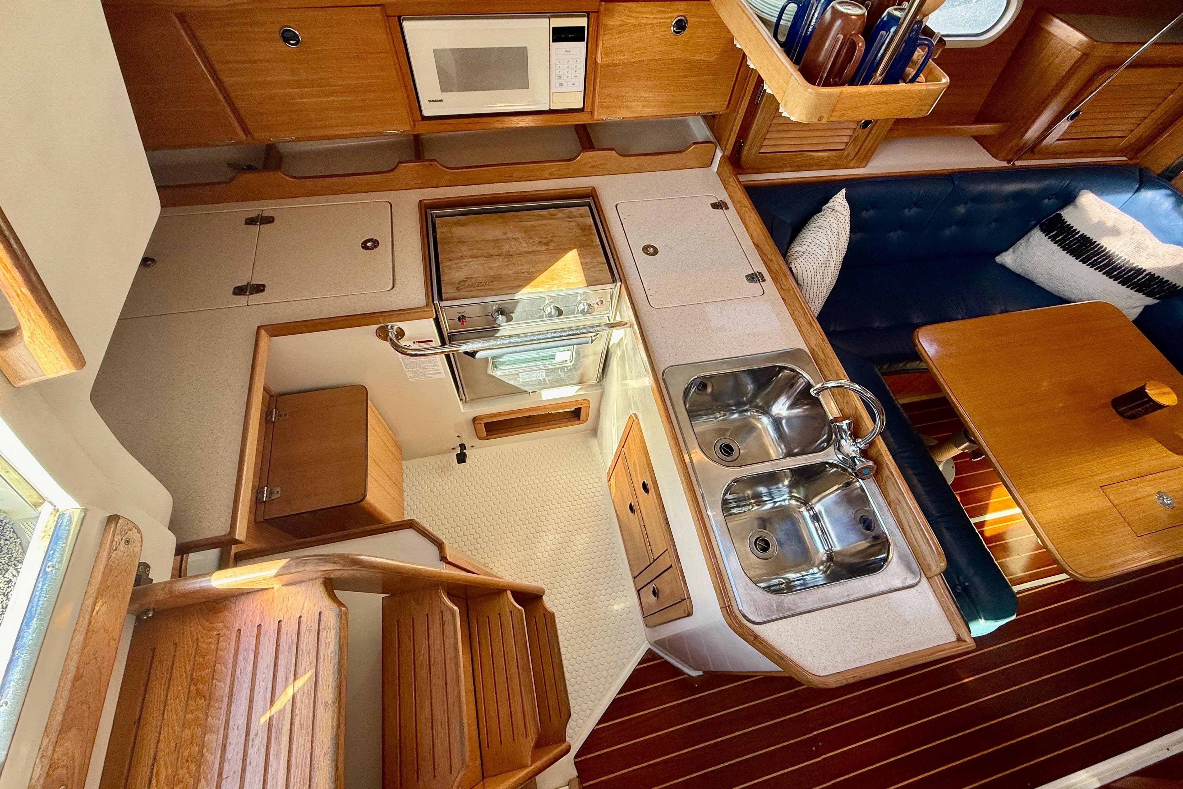 Interior of 2000 Catalina 36 MkII sailboat with kitchen and dining area.