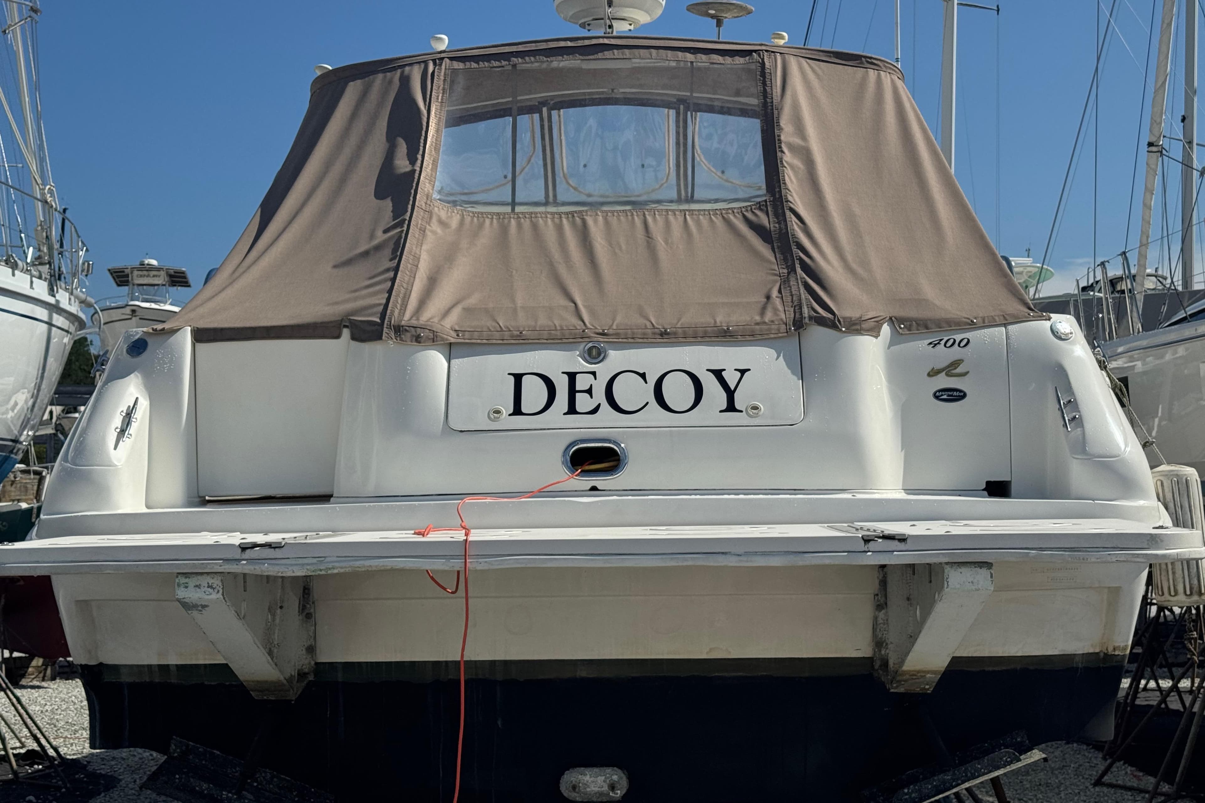1999 Sea Ray Sundancer 400 boat named "Decoy" with brown canvas cover.