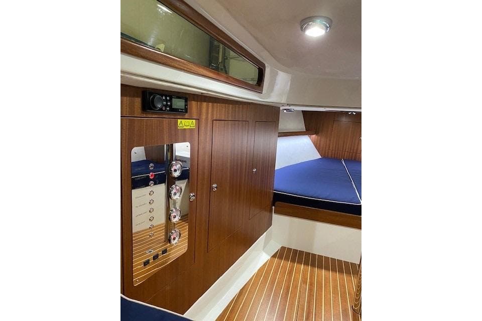 Interior of 2021 Leonardo Yachts Eagle 38, featuring wood paneling and a cozy cabin.