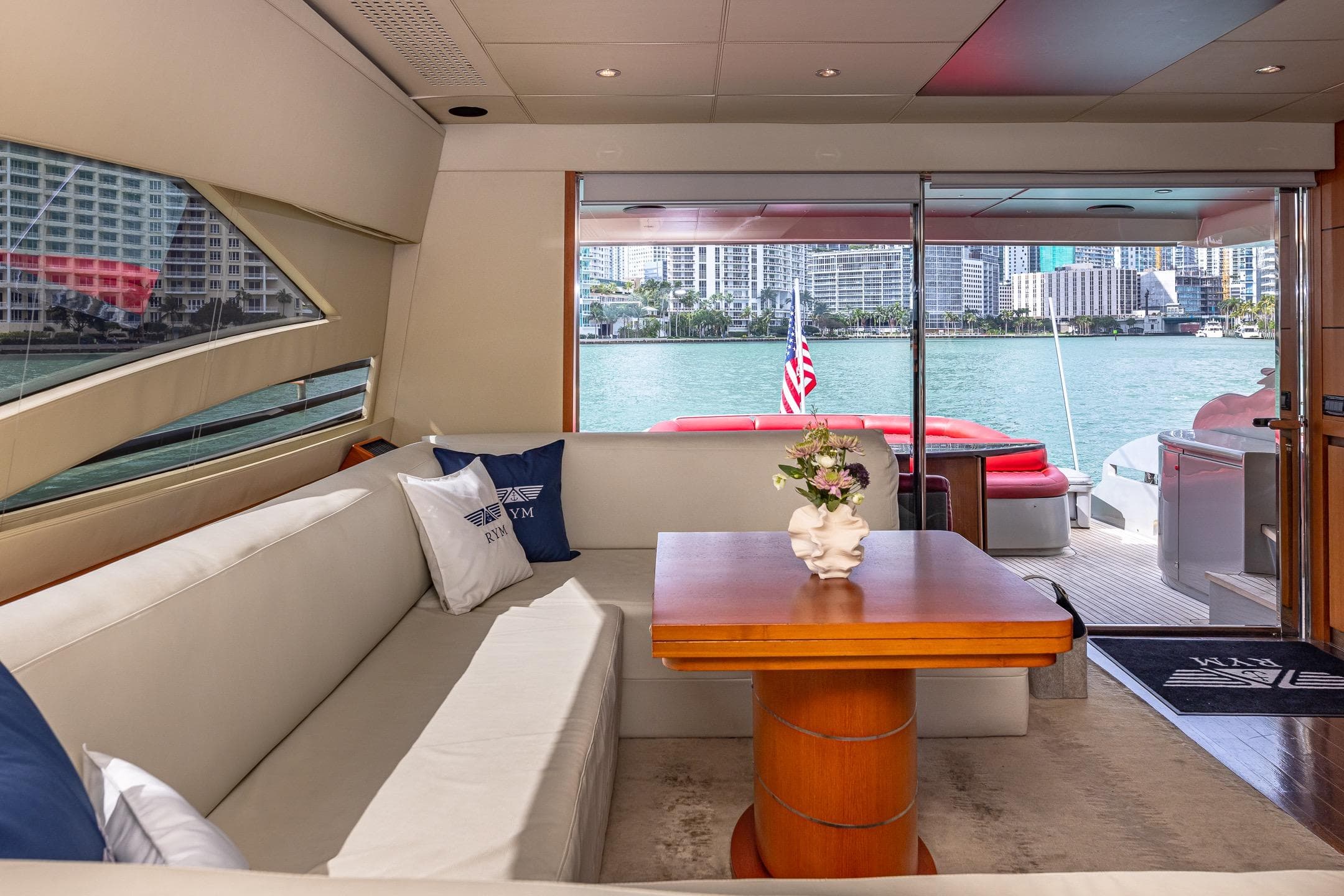 Luxurious interior of 2008 Pershing 90 yacht with waterfront view and elegant seating area.