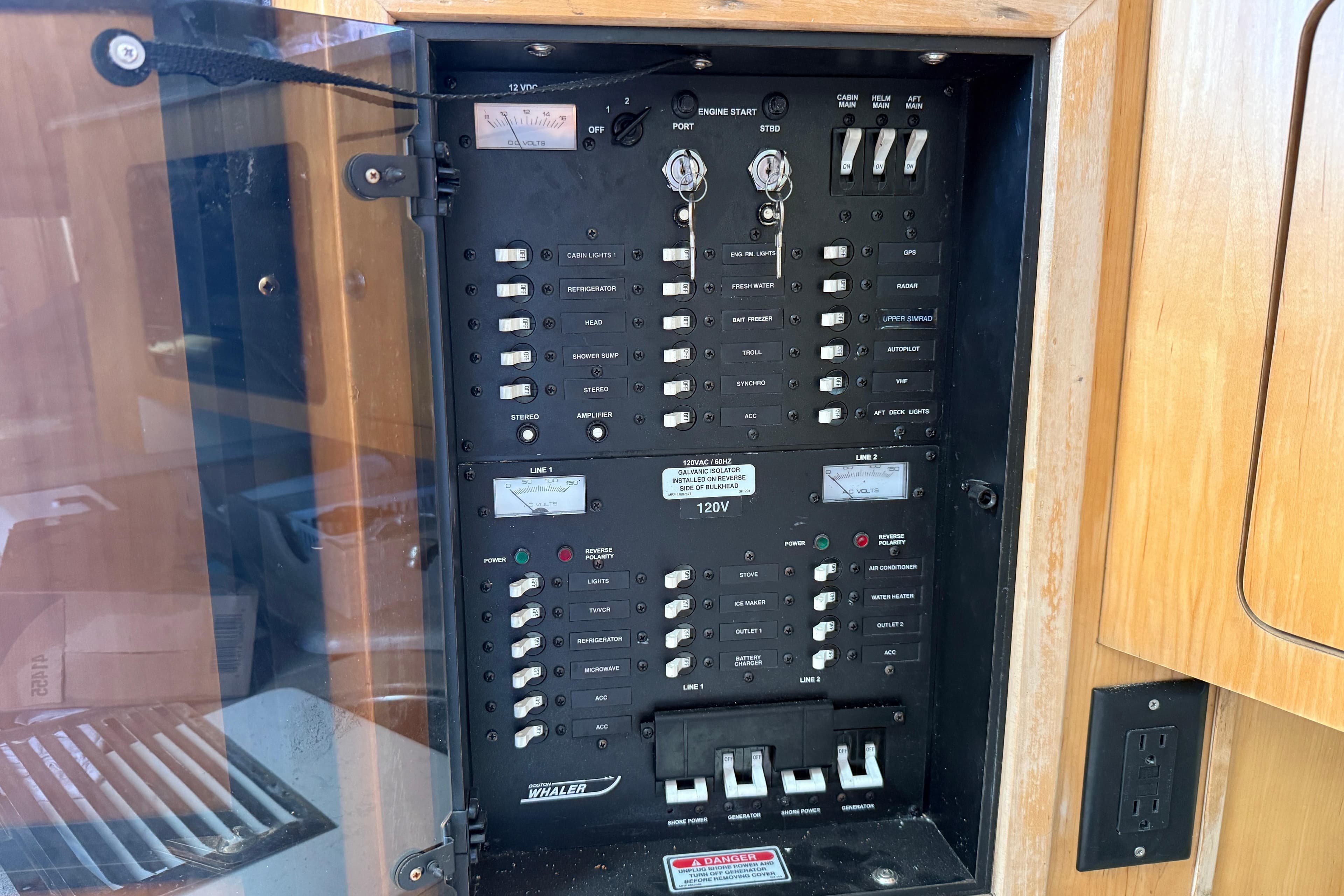Electrical panel of a 2002 Boston Whaler 350 Defiance boat, featuring various switches and controls.
