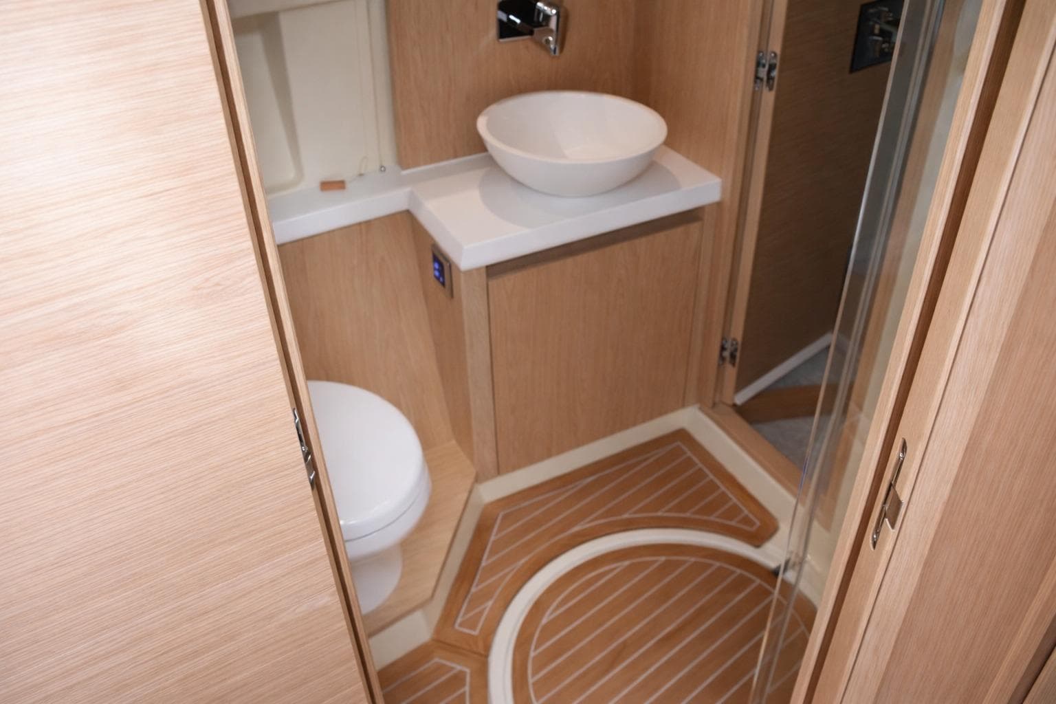 Luxurious bathroom in 2016 Beneteau Monte Carlo 5 yacht, featuring modern fixtures and wood accents.