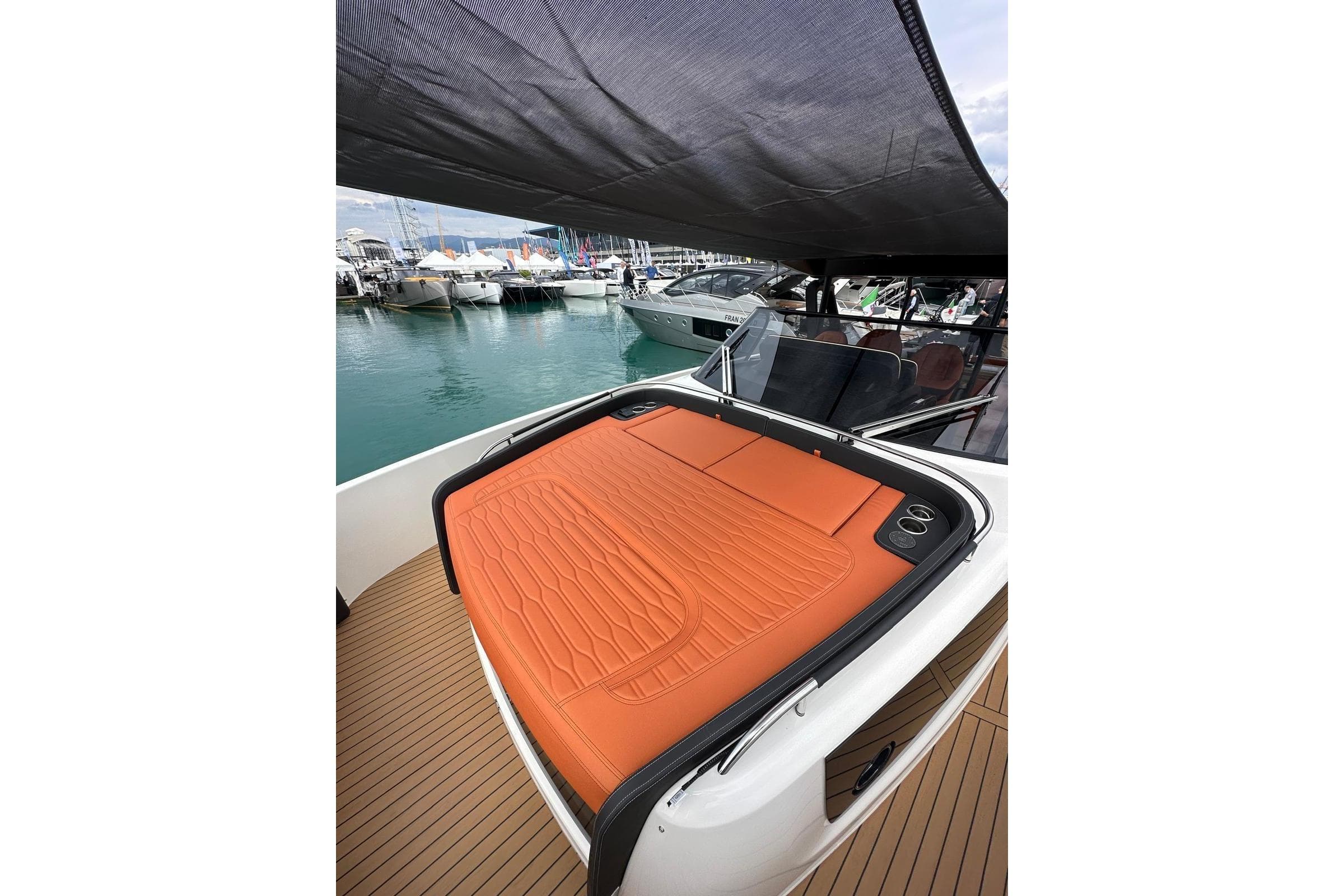 2025 Cranchi A46 Luxury Tender with orange sunbed at marina.