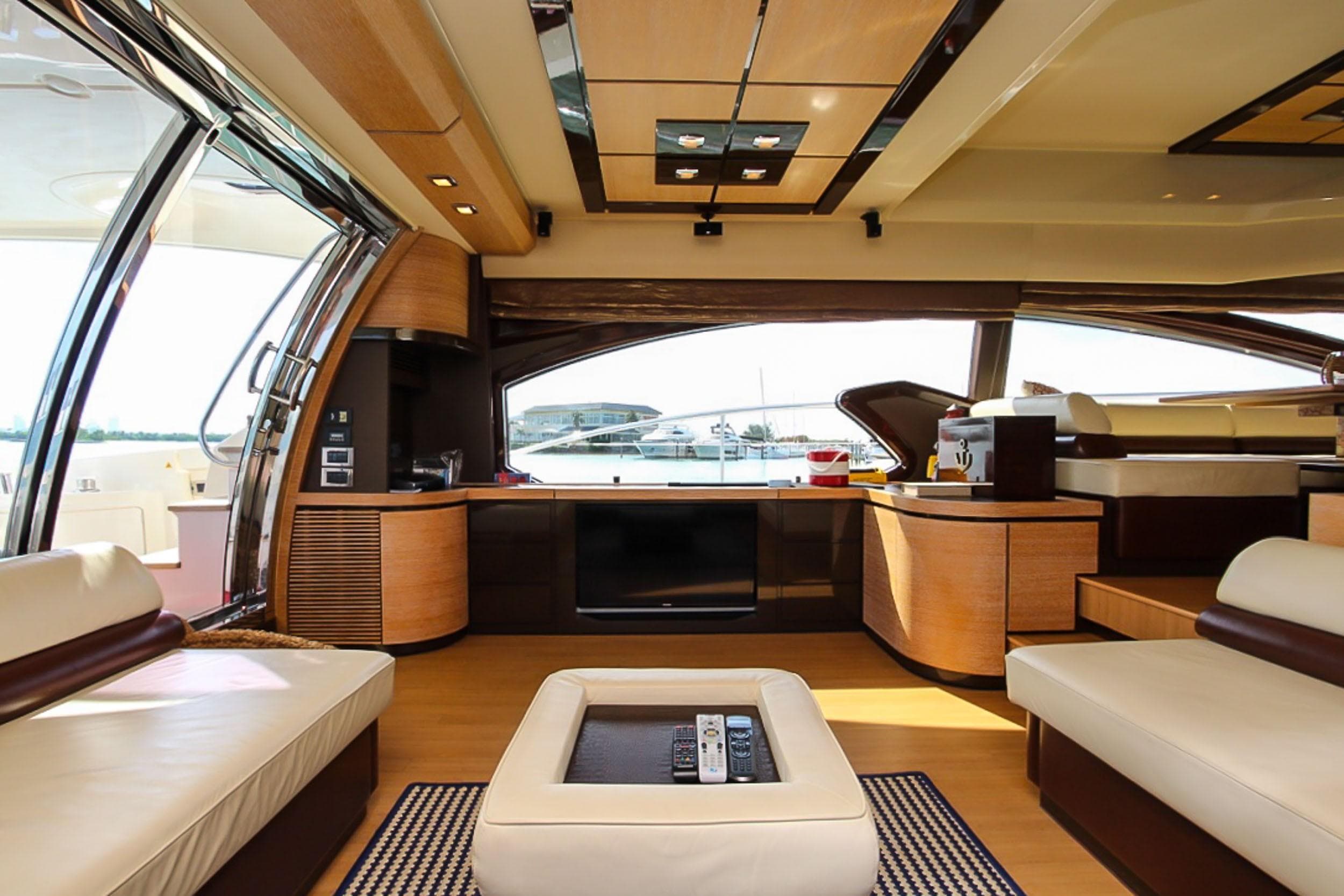 Luxurious interior of a 2011 Azimut 70 yacht with modern furnishings and panoramic windows.