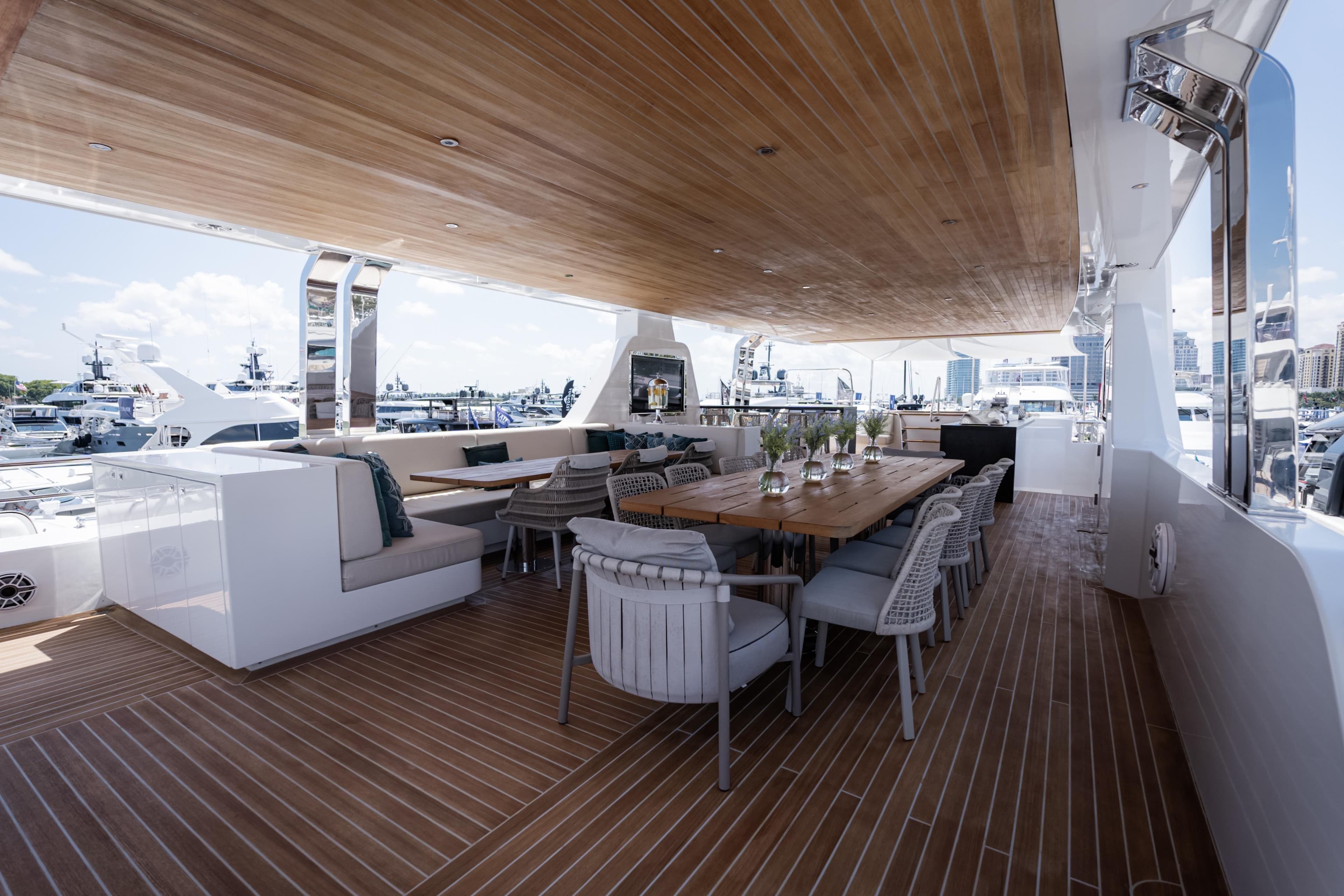 Luxurious 2020 Alpha Alfresco 125 yacht deck with elegant dining area and marina view.