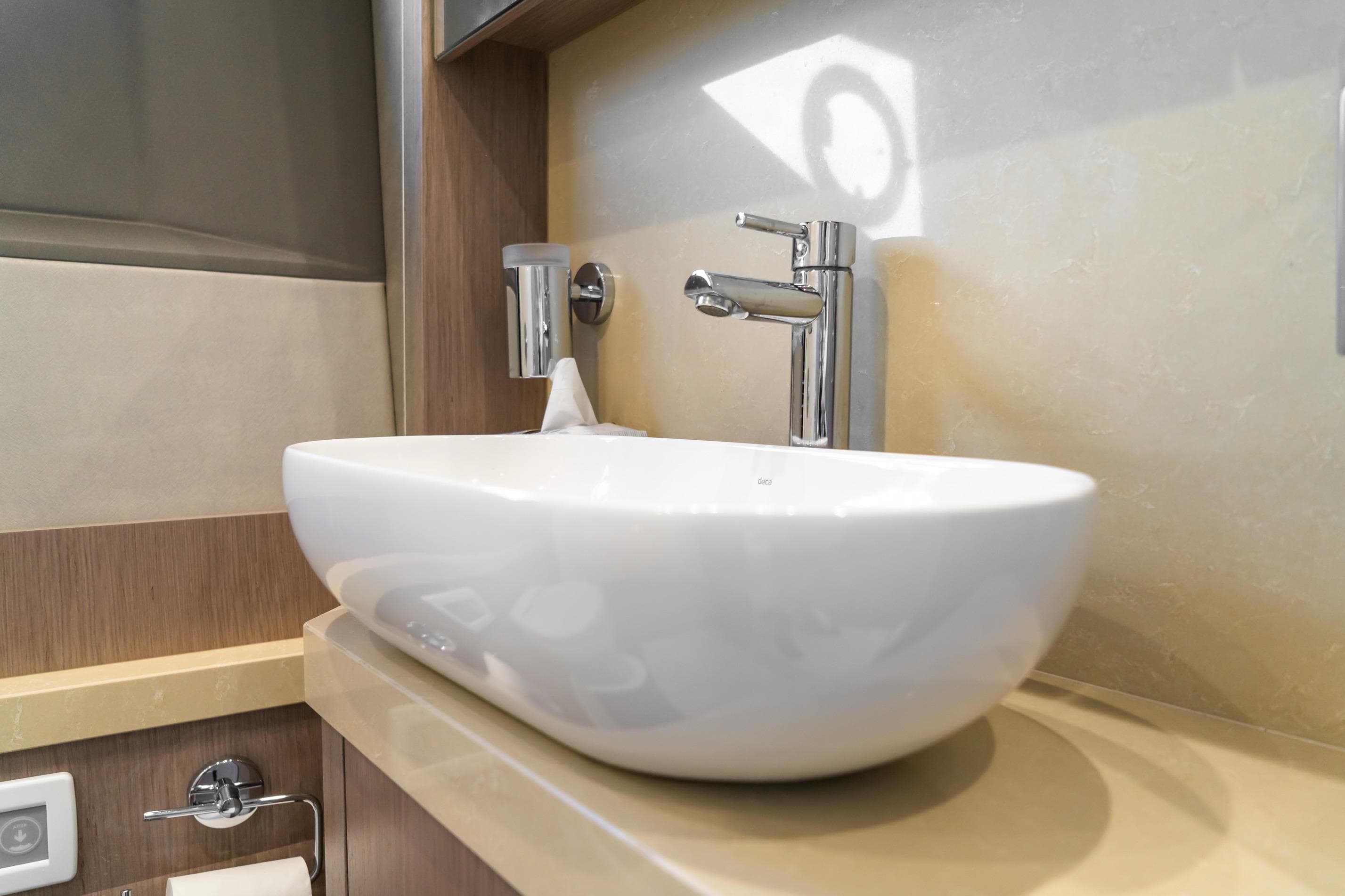 Modern bathroom sink on 2018 Sunseeker Manhattan 52 yacht, featuring sleek design and chrome fixtures.
