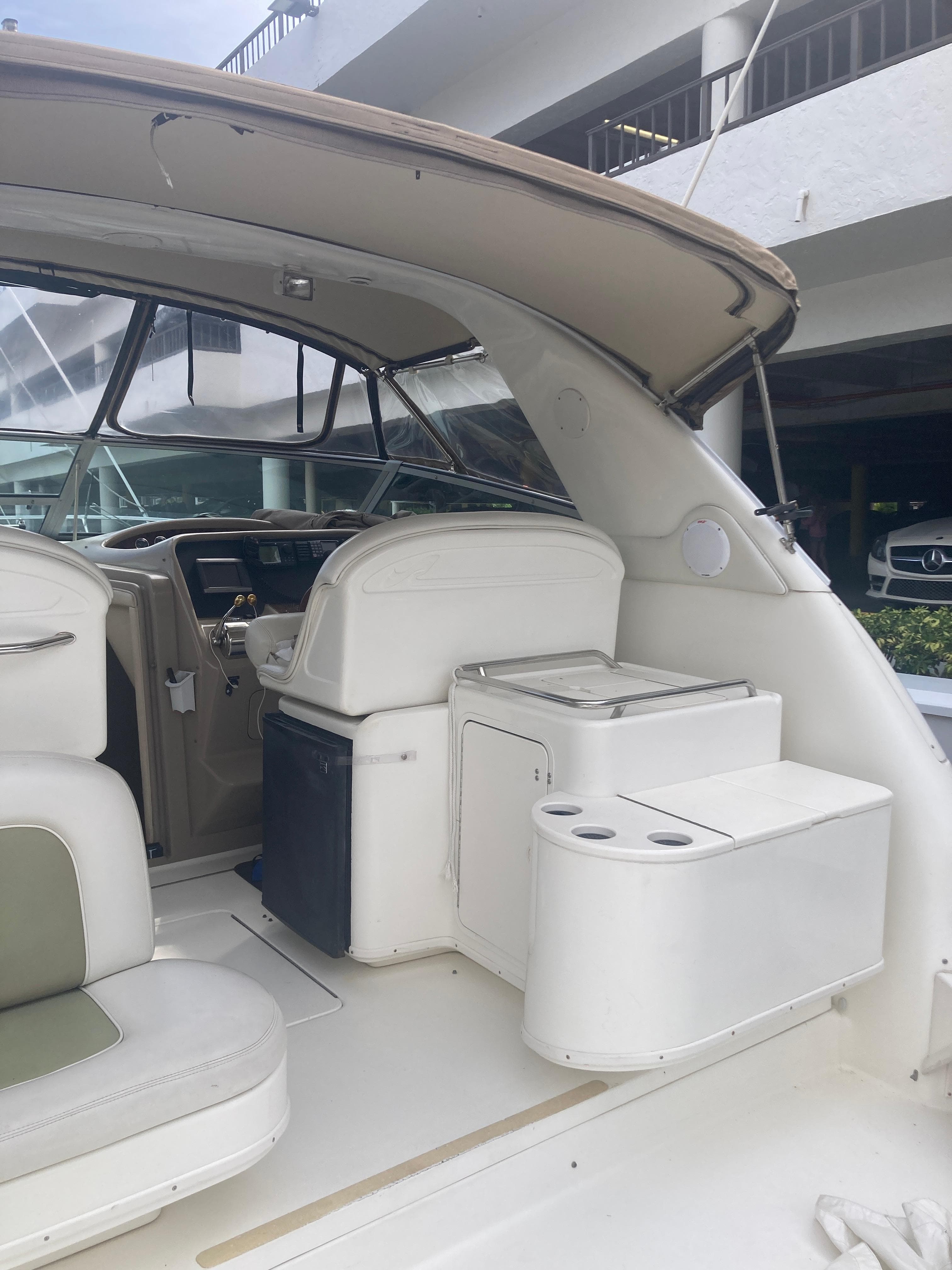 1999 Sea Ray 330 Express Cruiser interior with seating and helm.
