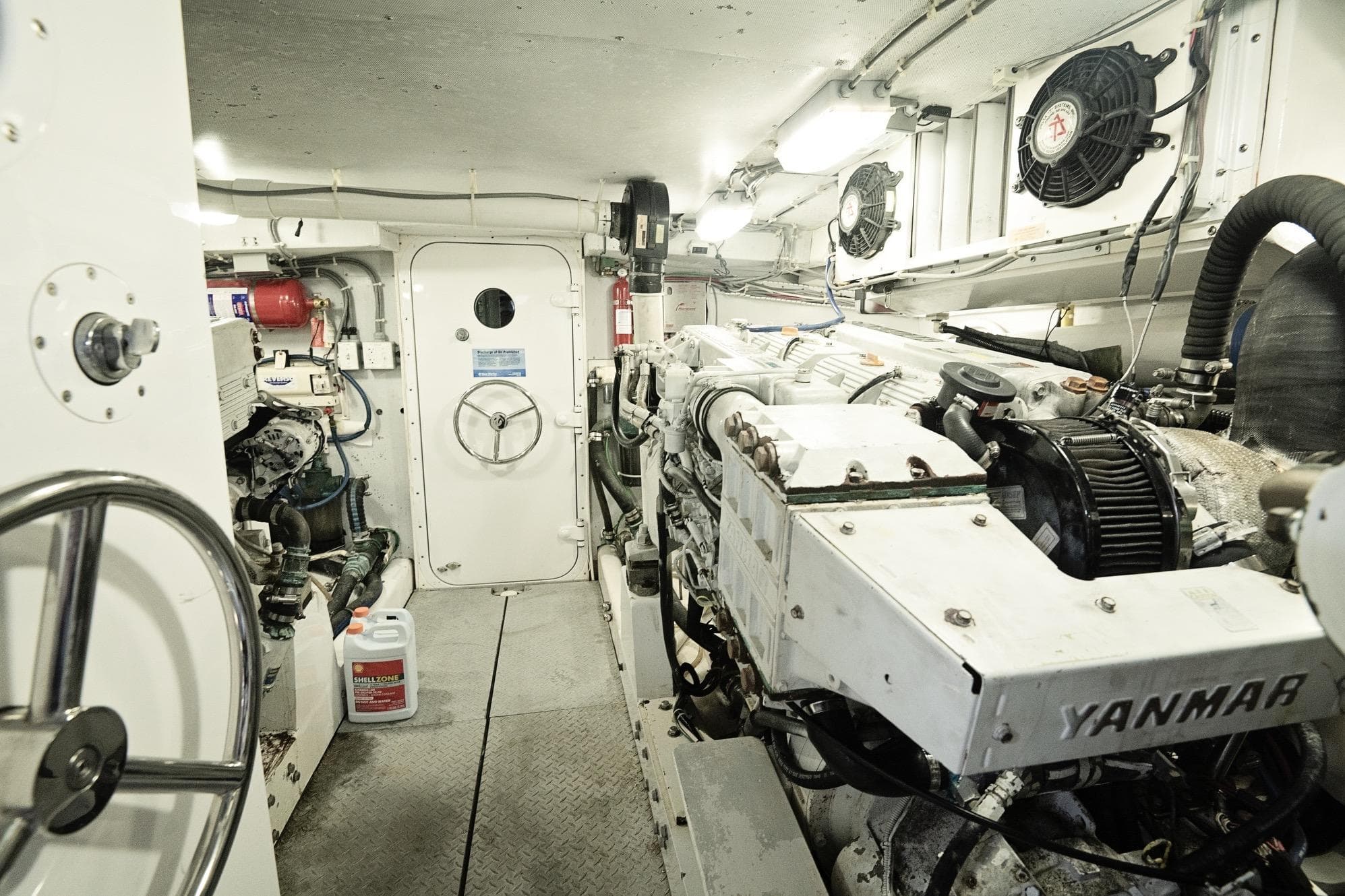 Engine room of a 2007 Pilot Cruiser Expedition, featuring Yanmar engines and mechanical equipment.