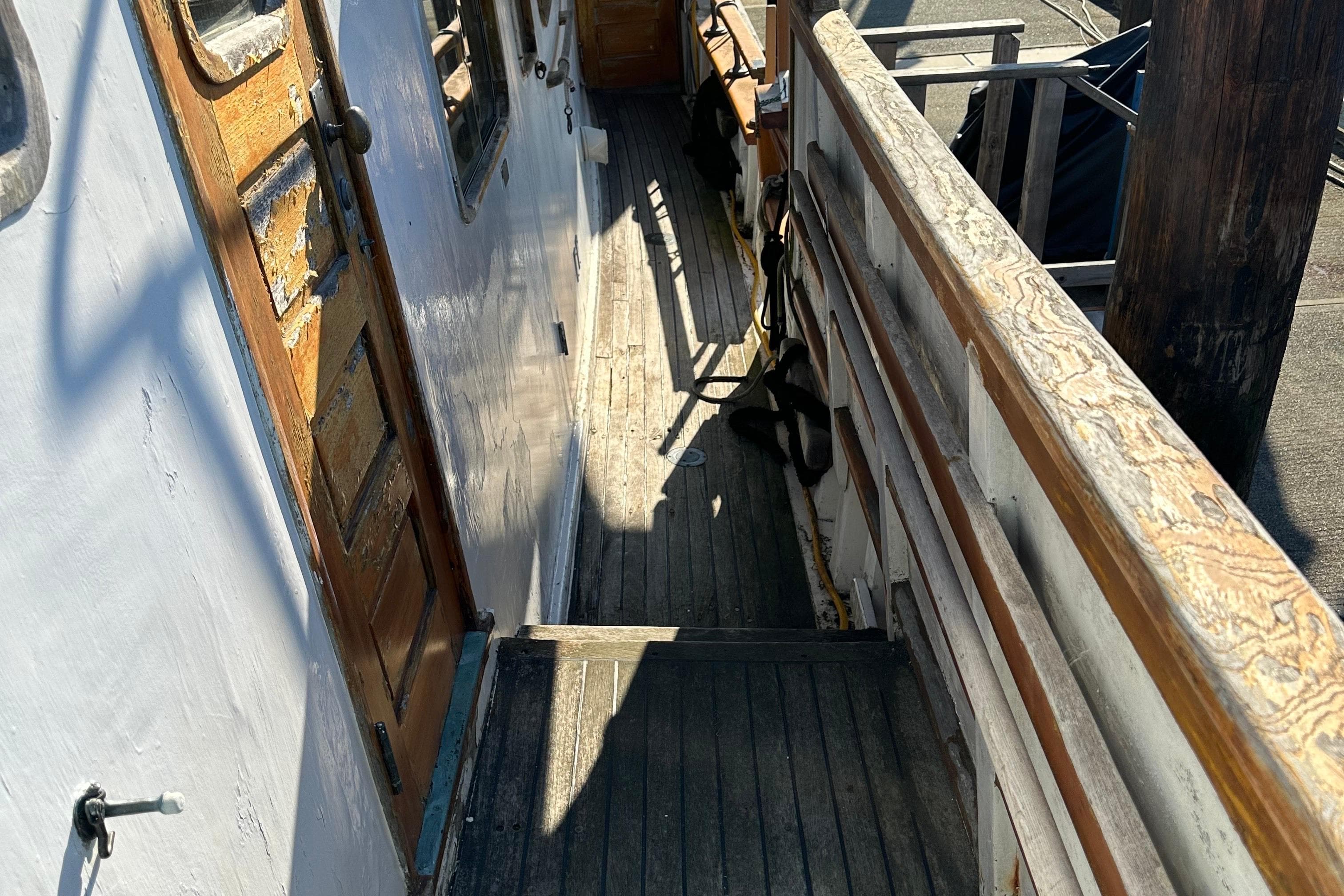 1971 Southern Marine MALAHIDE Pilothouse LRC deck with wooden railings and door.