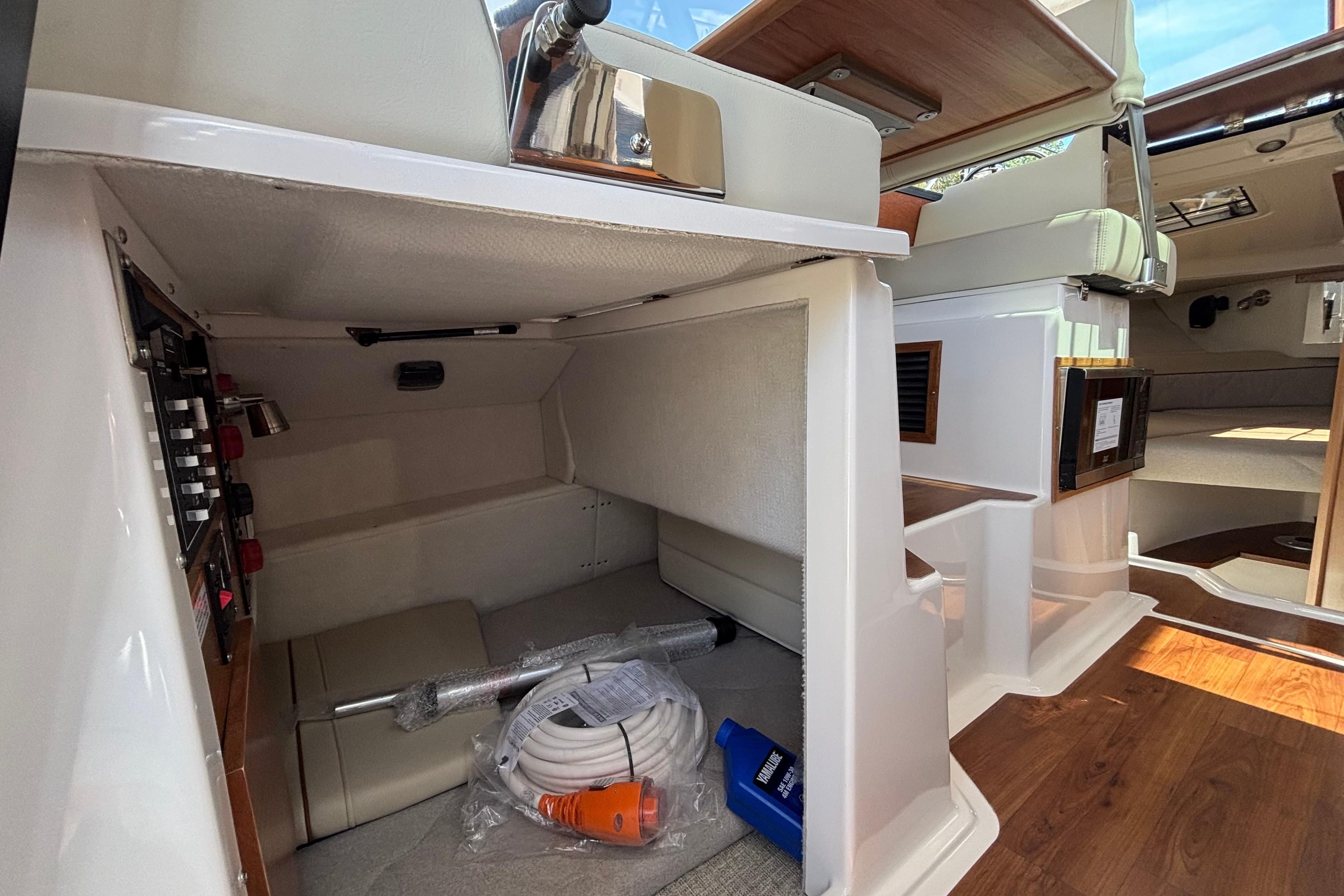 Interior view of 2026 Cutwater C-248 Coupe boat, showcasing storage and seating area.