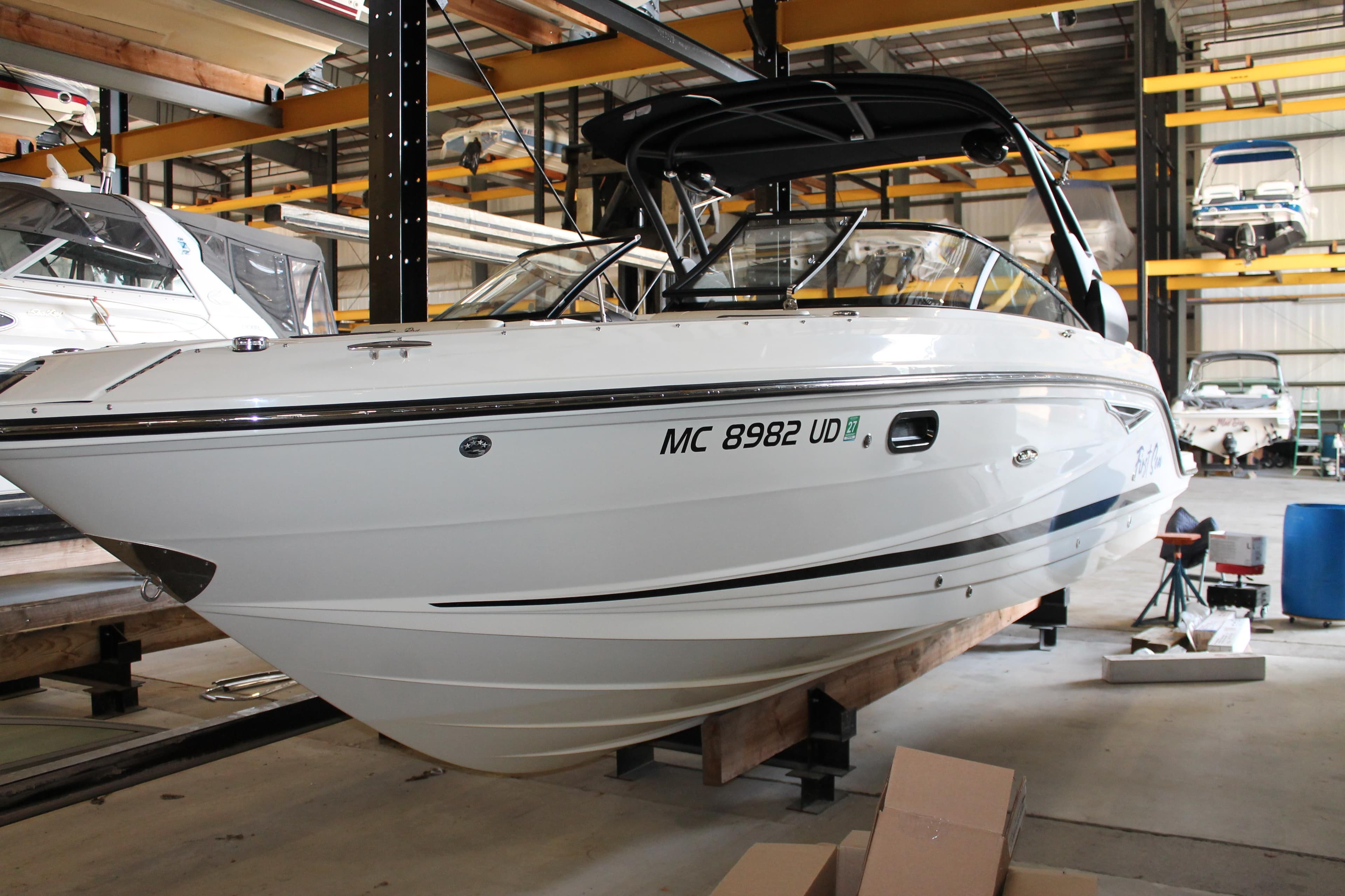 2018 Sea Ray 280 SLX boat in storage, showcasing sleek design and modern features.