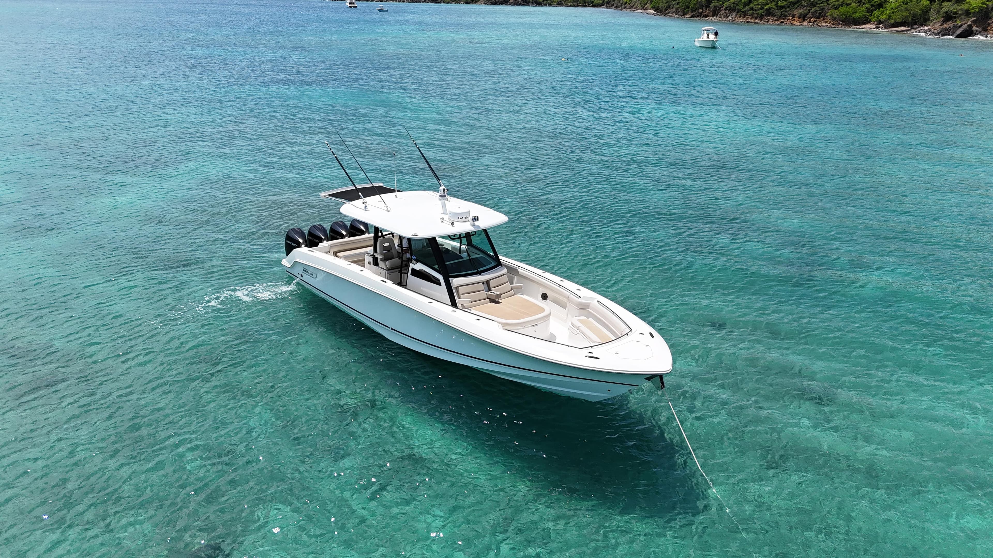 2020 Boston Whaler 380 Outrage boat on clear turquoise water.