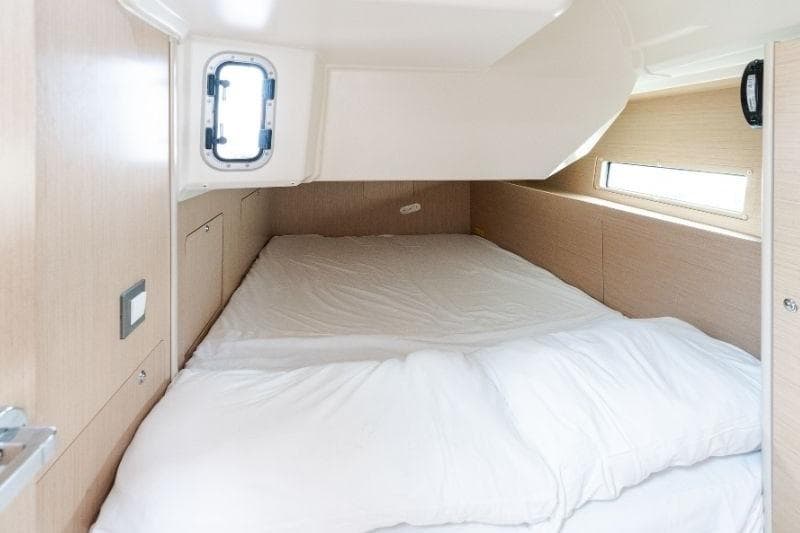 Cozy cabin interior of 2021 Beneteau Oceanis 40.1 yacht with comfortable bedding.