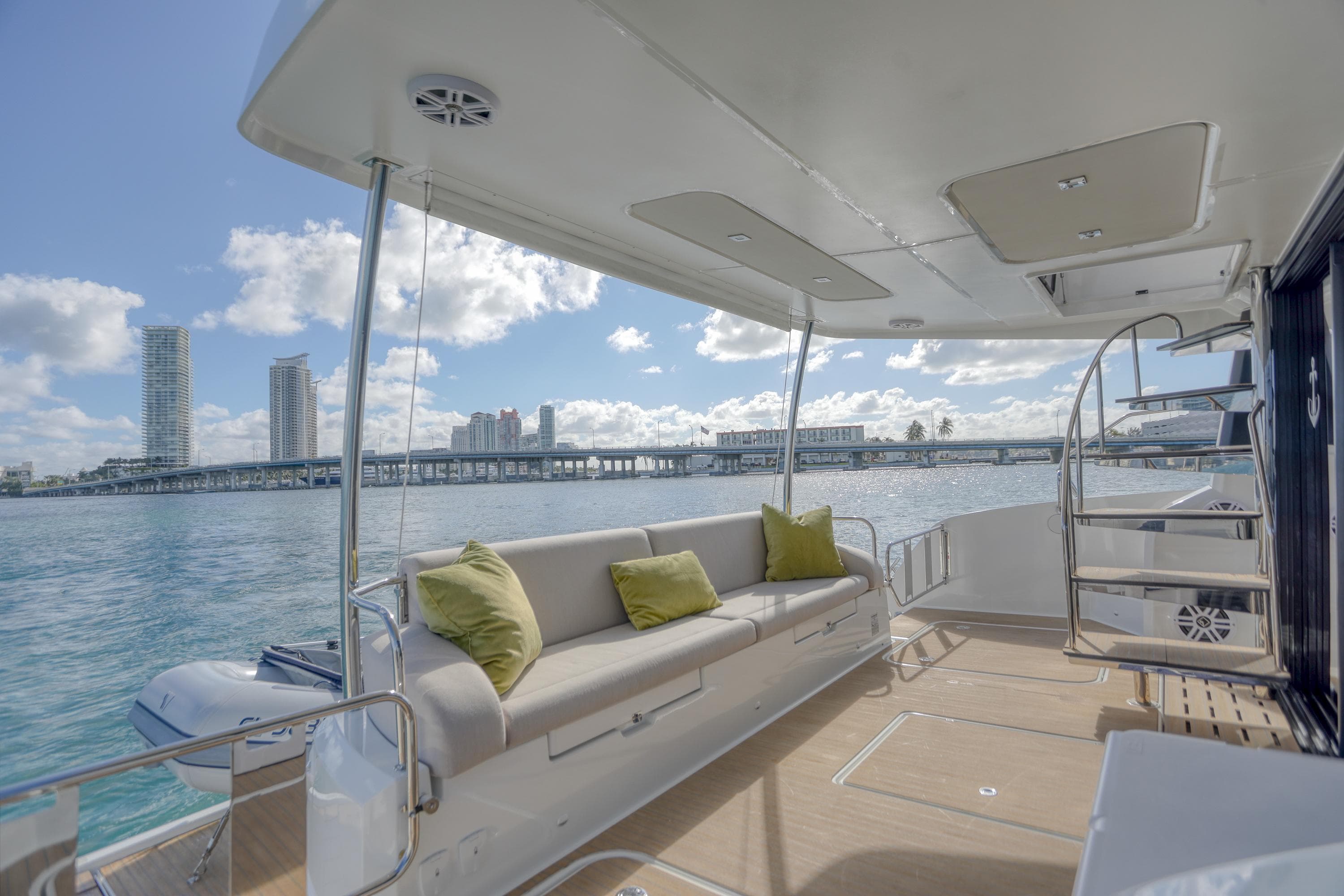 Luxurious 2022 Fountaine Pajot MY6 yacht deck with comfortable seating and scenic waterfront view.