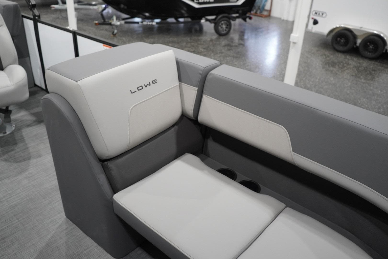 Gray and white seating on 2026 Lowe LS 190 boat, featuring cup holders.