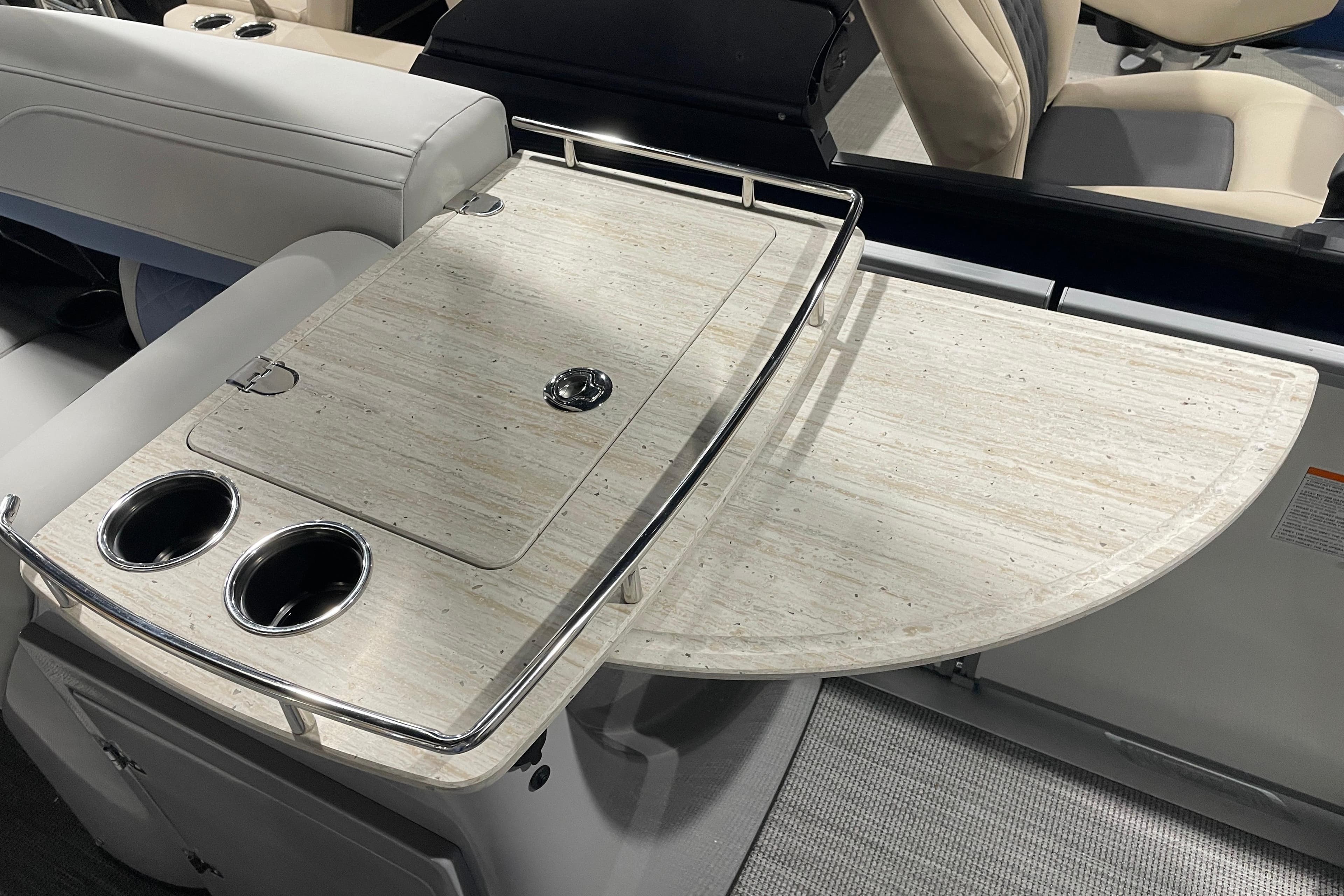 2026 Harris Grand Mariner SEL 250 boat interior with elegant table and cup holders.