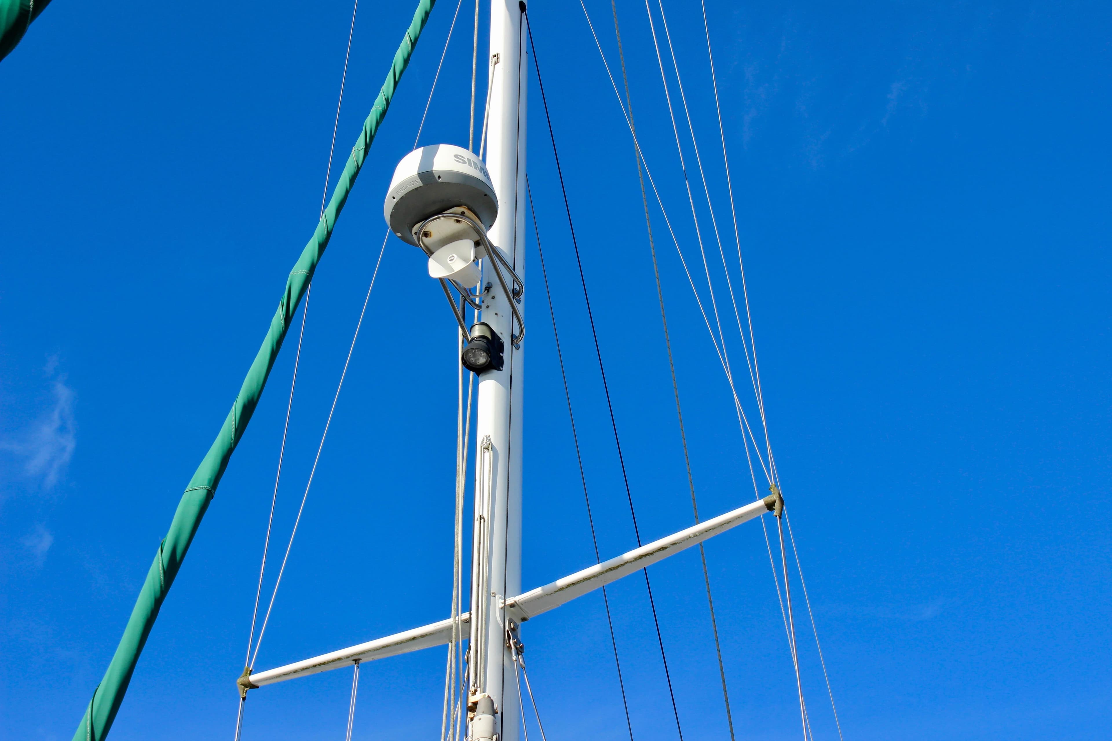 Mast of 1997 Valiant 39 sailboat against clear blue sky.