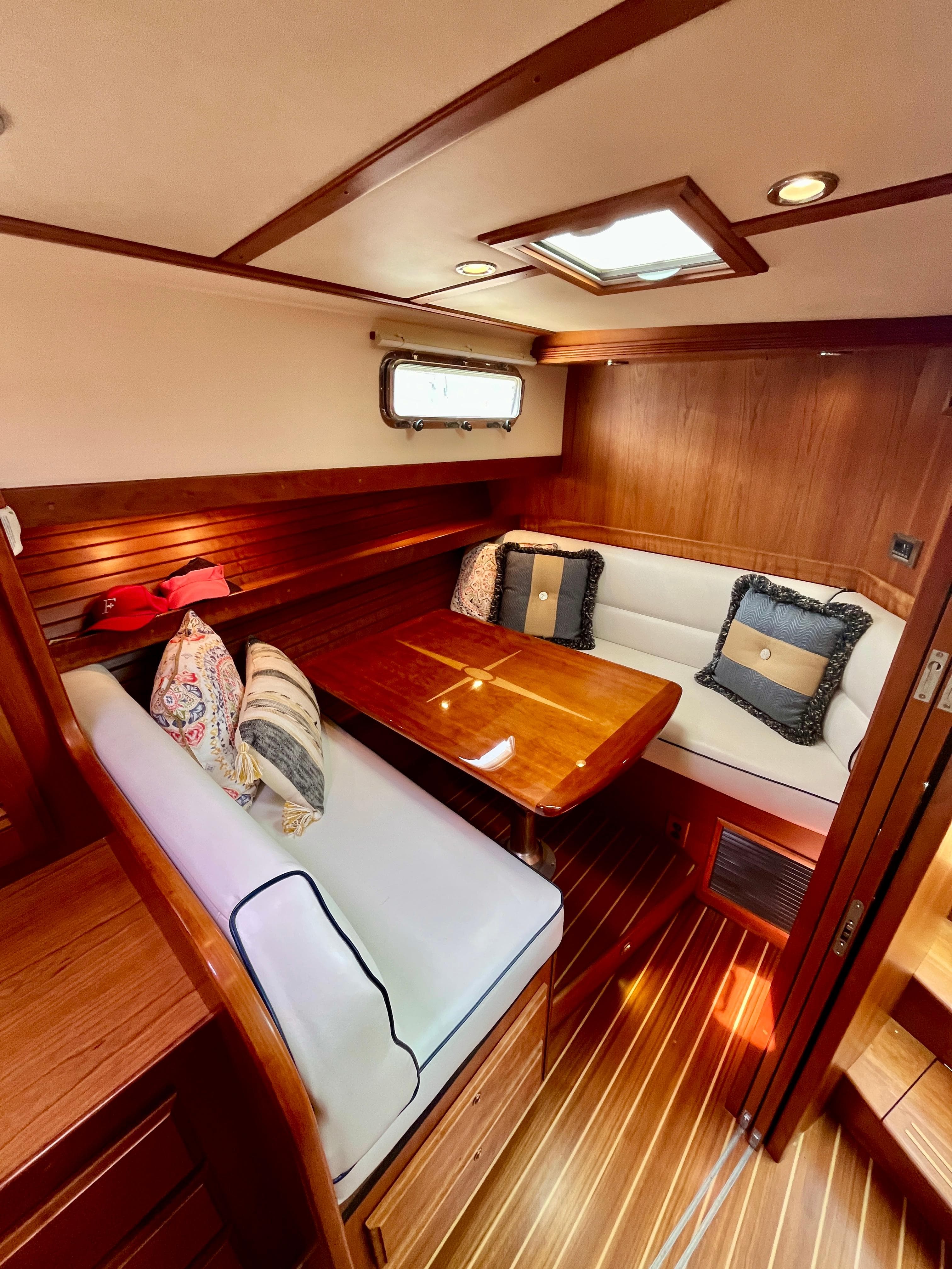 Luxurious interior of 2010 Sabre 40 Sedan yacht with wood finish and cozy seating.