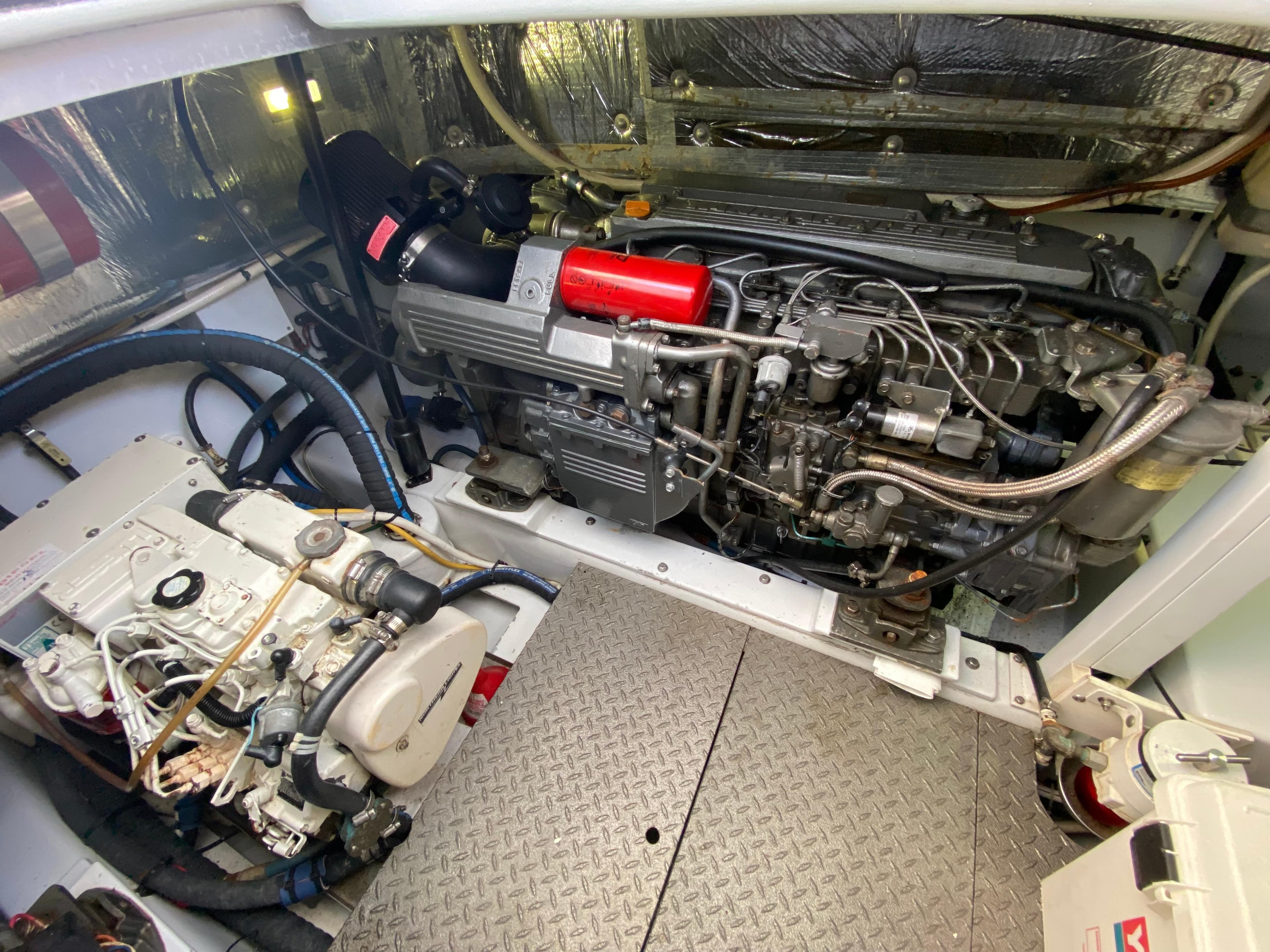 Engine room of a 1995 L&H 33 boat, featuring mechanical components and wiring.