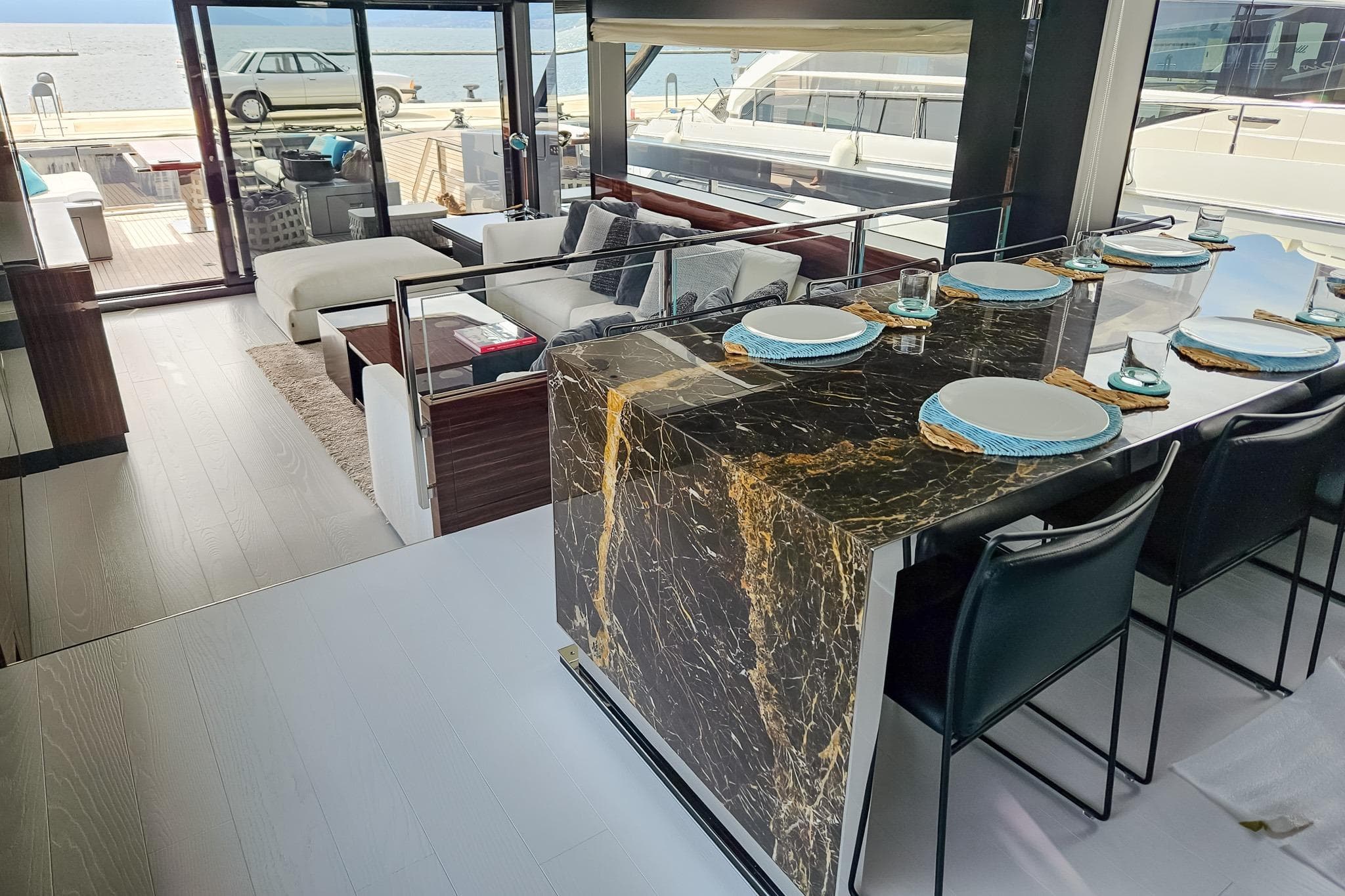 Luxurious interior of 2022 Riva 82' Diva yacht with elegant dining area and sea view.