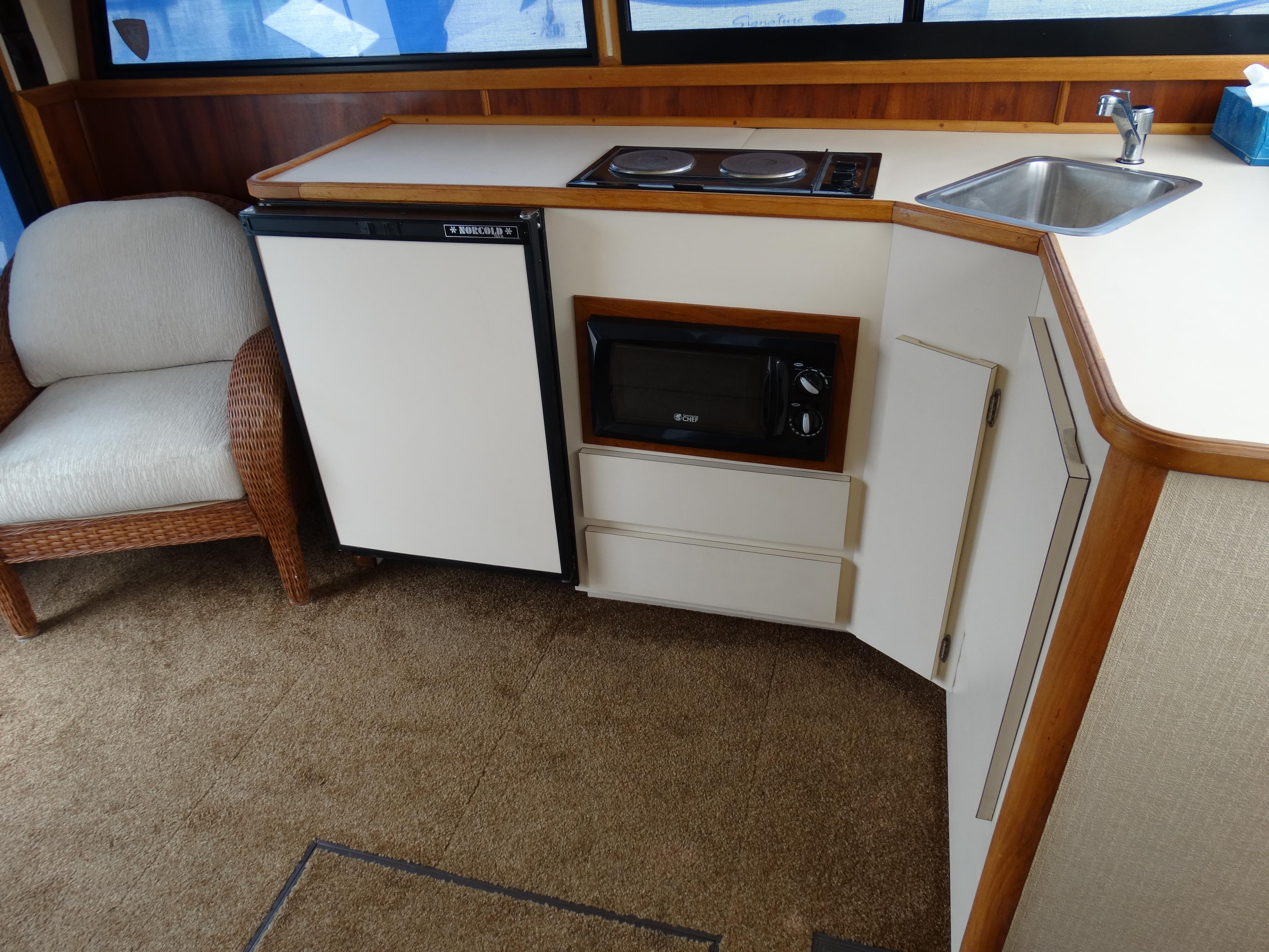Interior of 1991 Egg Harbor 33 Sedan with kitchenette and seating area.