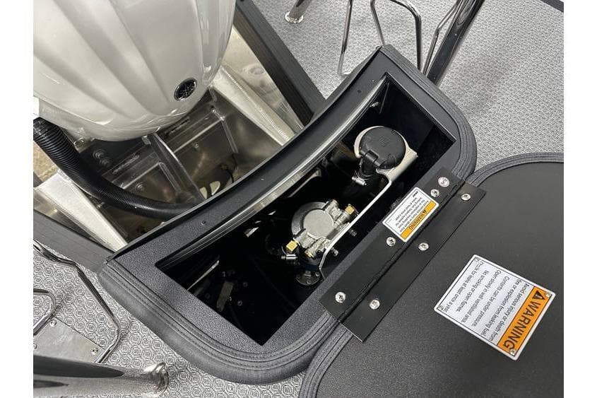 Open engine compartment of 2026 Evotti 723CS boat, showing mechanical components and warning labels.