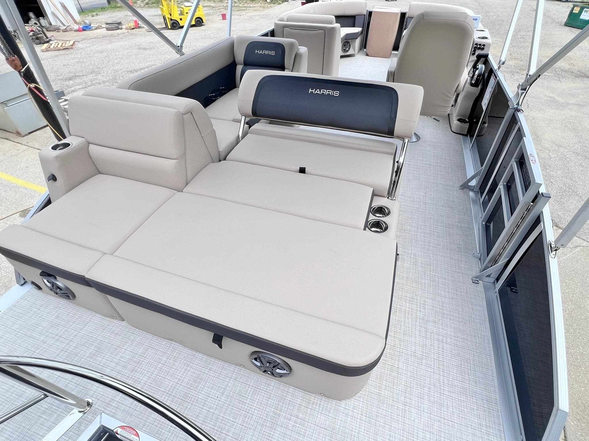 2025 Harris Cruiser 230 pontoon boat interior with beige seating and cup holders.