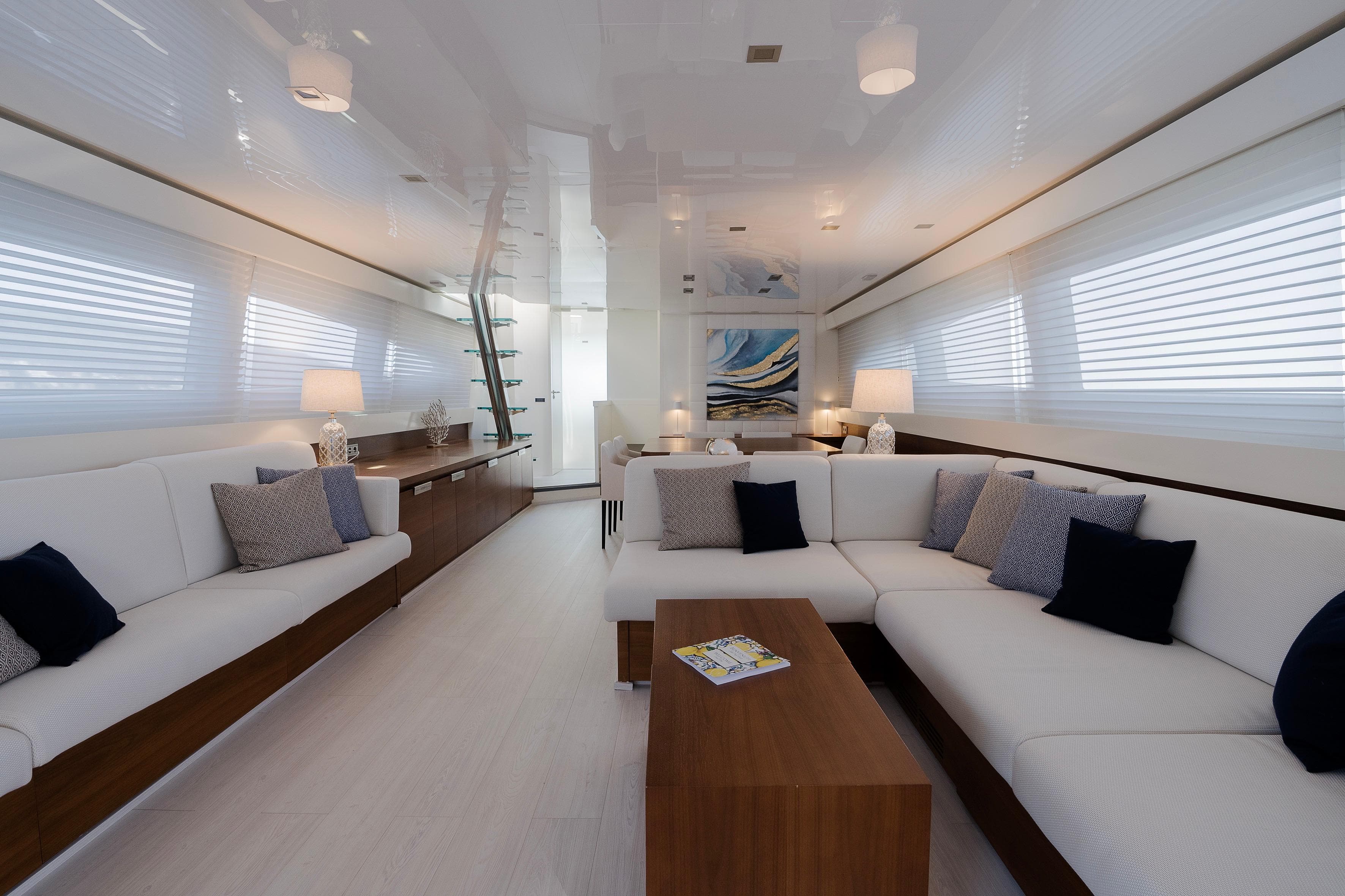 Luxurious interior of 2007 Canados 86 yacht with modern white and wood decor.