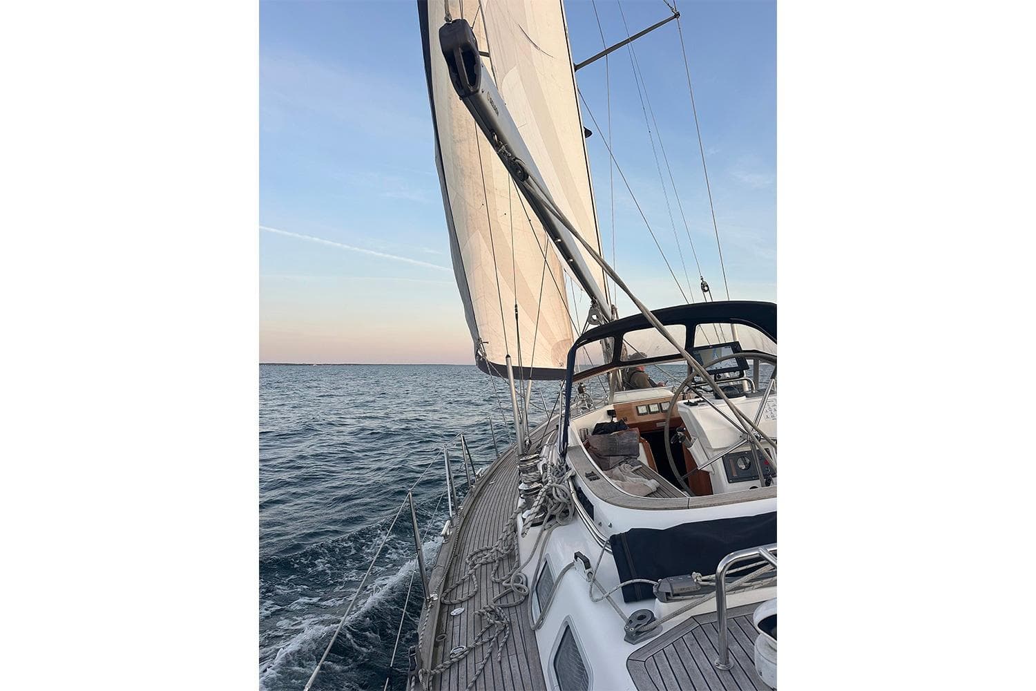 Sailing on a 2004 Najad 460 yacht with open sea and clear sky.
