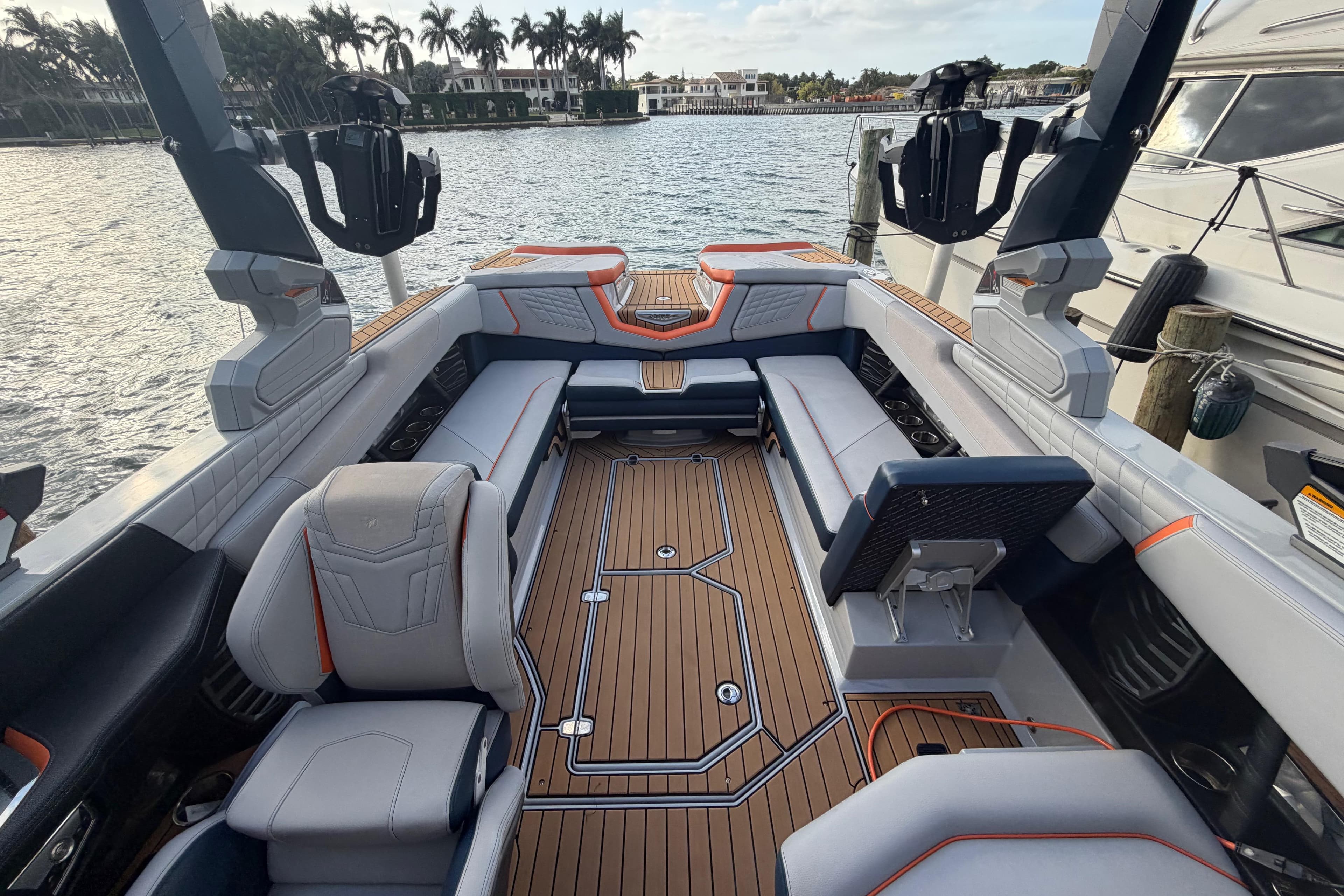 2022 Nautique Super Air Nautique G25 interior with luxurious seating and teak flooring.