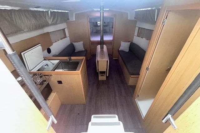 Interior of 2017 Beneteau Oceanis 38.1 yacht, featuring modern kitchen and seating area.