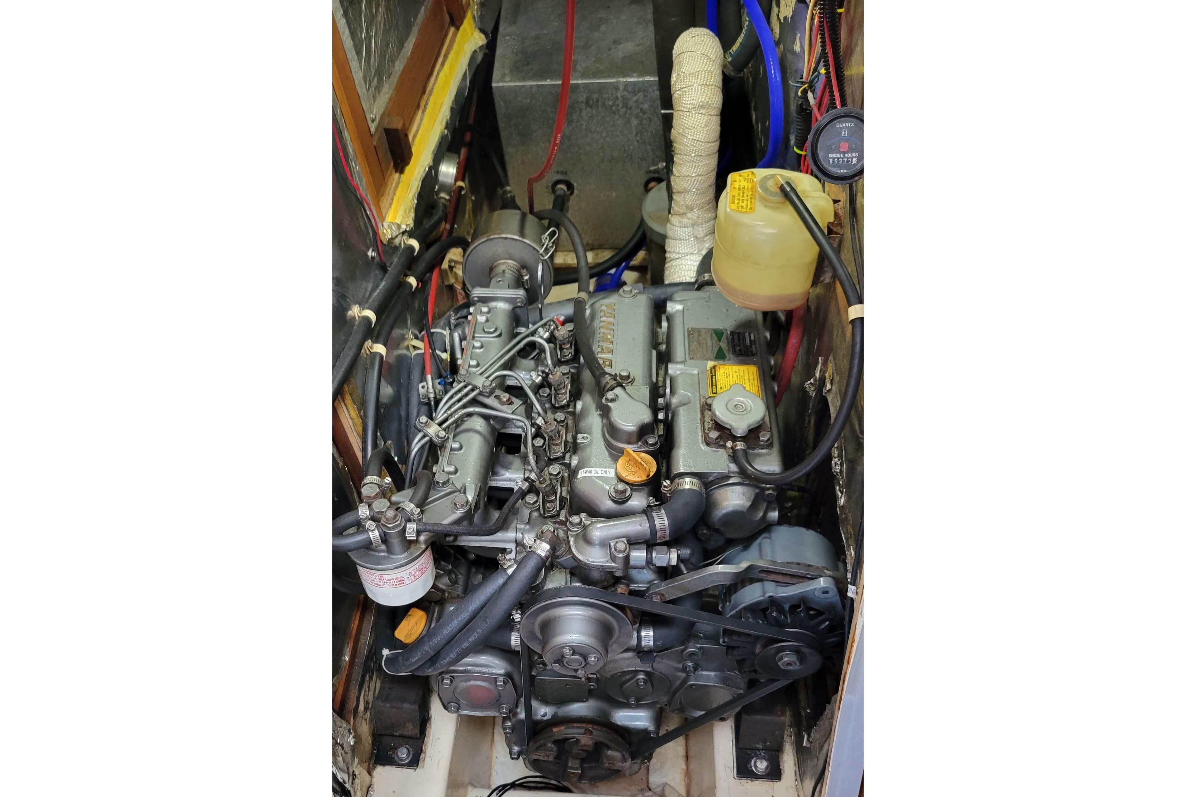 Engine compartment of a 1991 Catalina 42 MkII sailboat, showcasing detailed mechanical components.