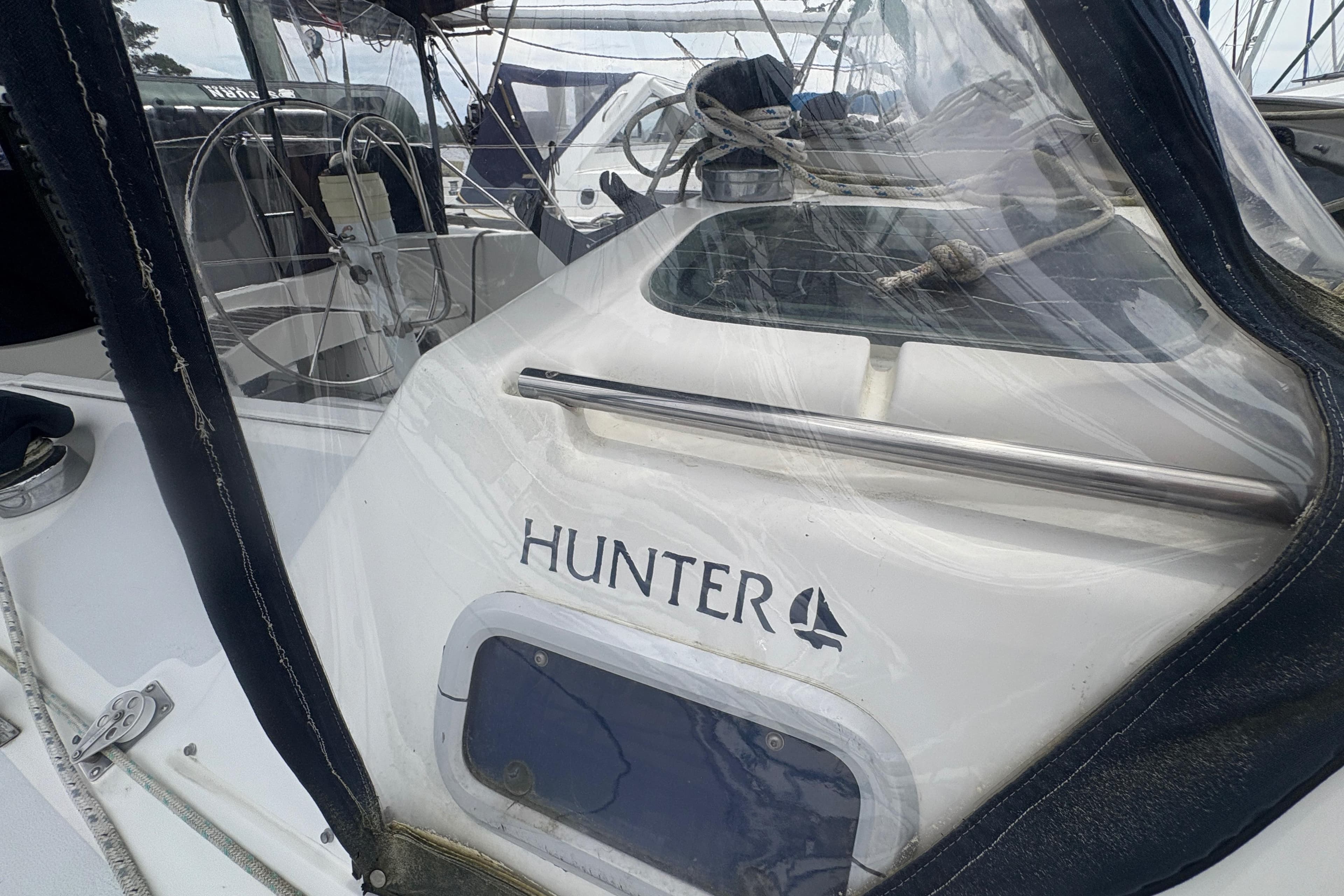1989 Hunter Vision 32 sailboat cockpit with steering wheel and protective cover.