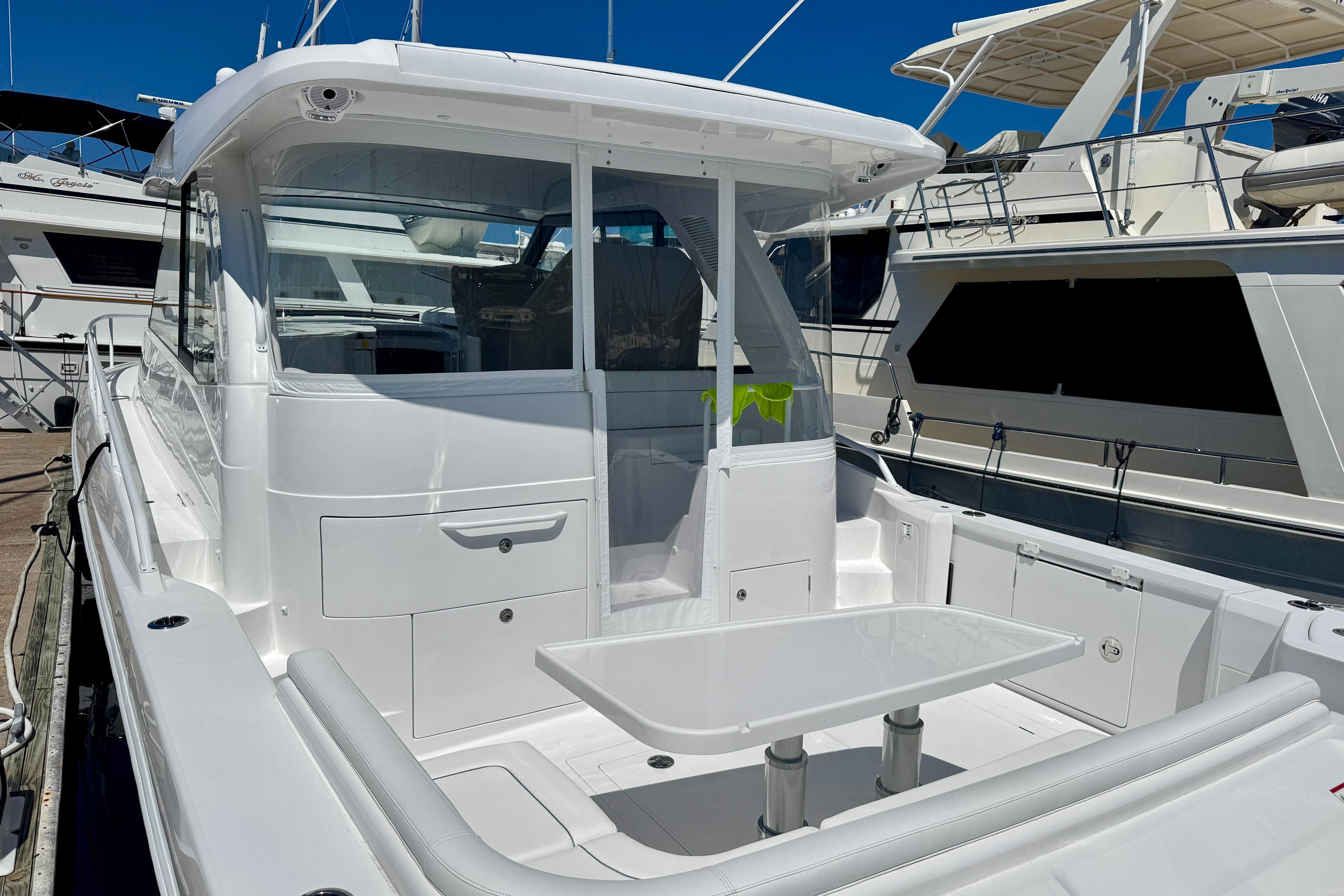 2025 Intrepid 50 Evolution yacht docked, featuring sleek white design and spacious deck area.