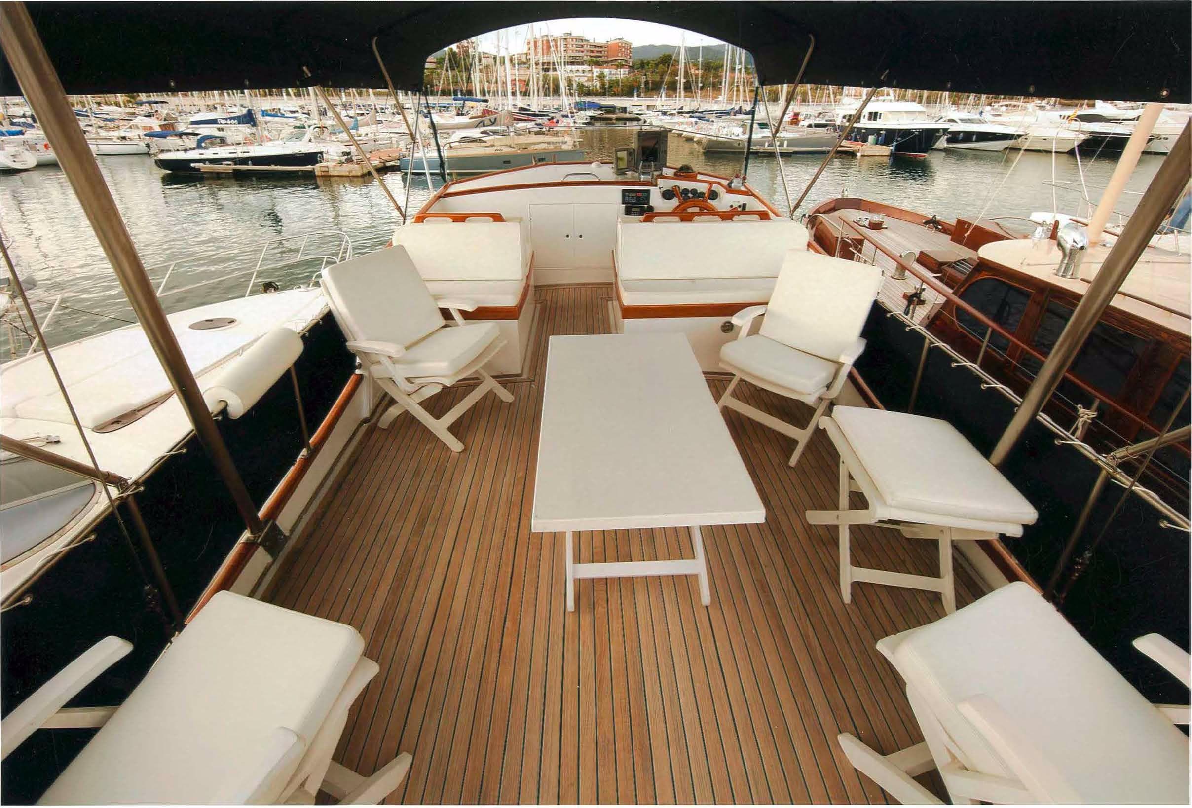 1980 Grand Banks 42 Classic yacht interior with seating and table, docked at a marina.