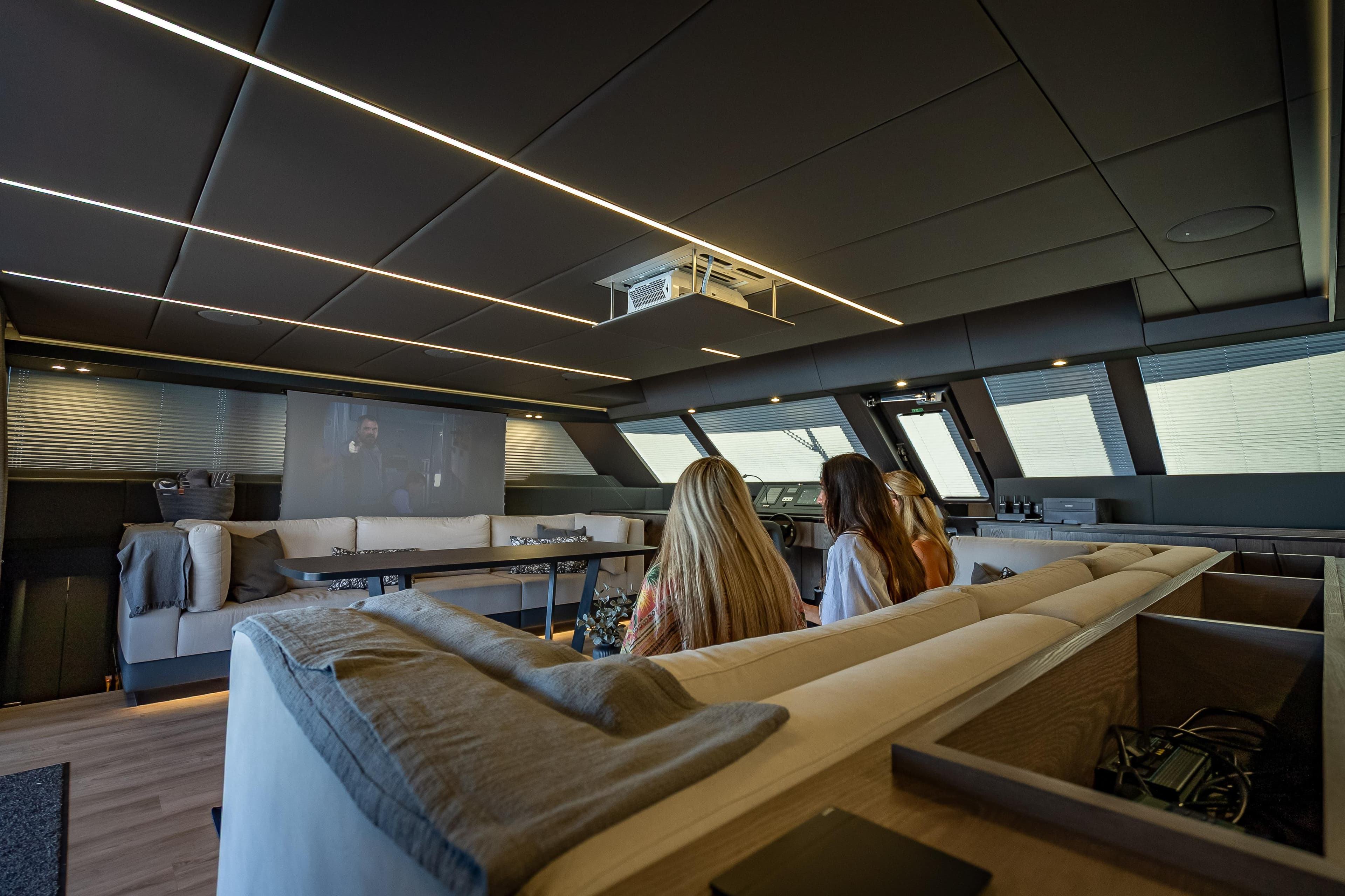 Luxurious interior of 2026 Sunreef 60 Power yacht with modern seating and entertainment system.