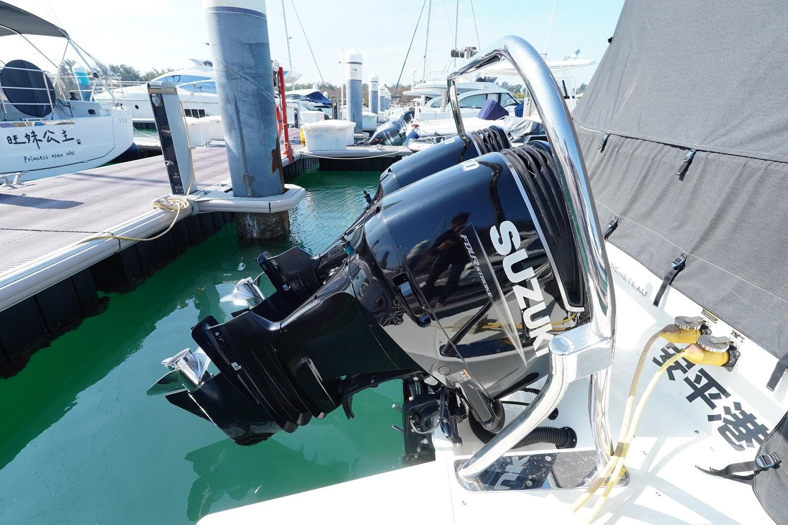 2023 Beneteau Gran Turismo 32 with Suzuki outboard motor at marina dock.