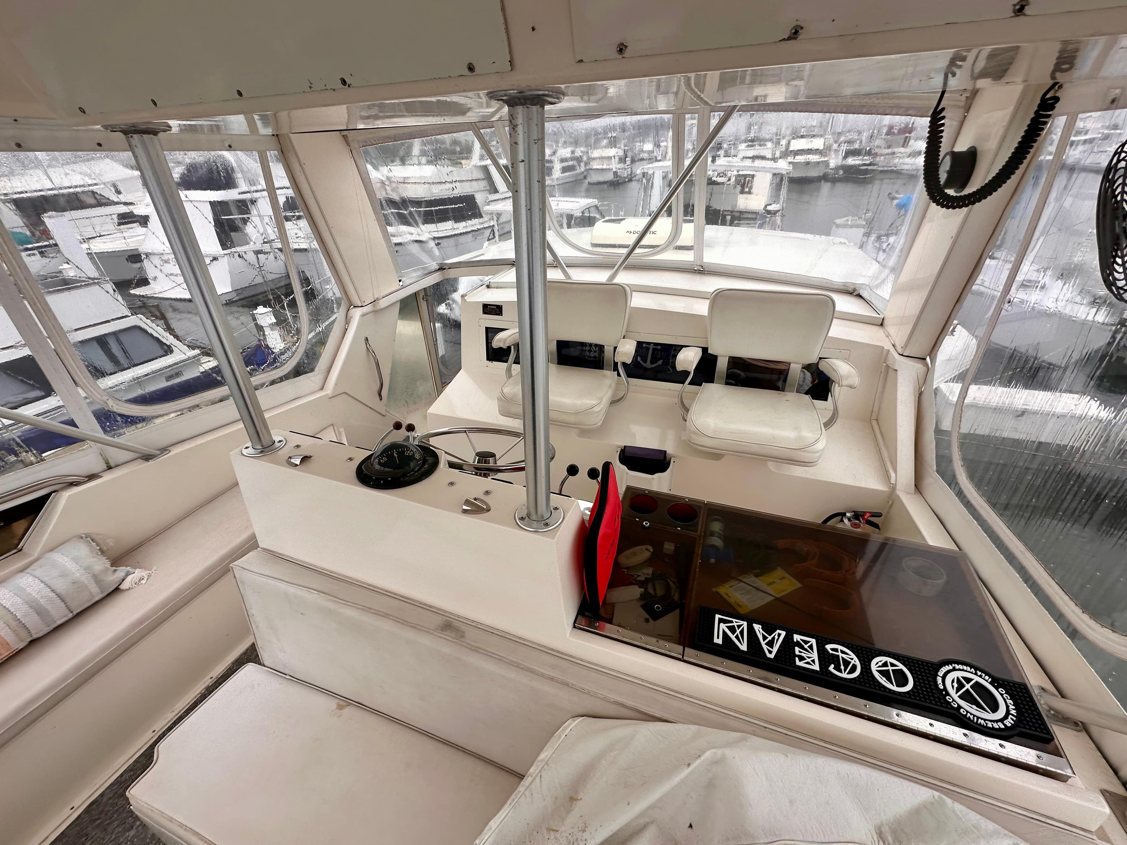 1989 Viking 44 Motor Yacht interior with helm, seating, and marina view.