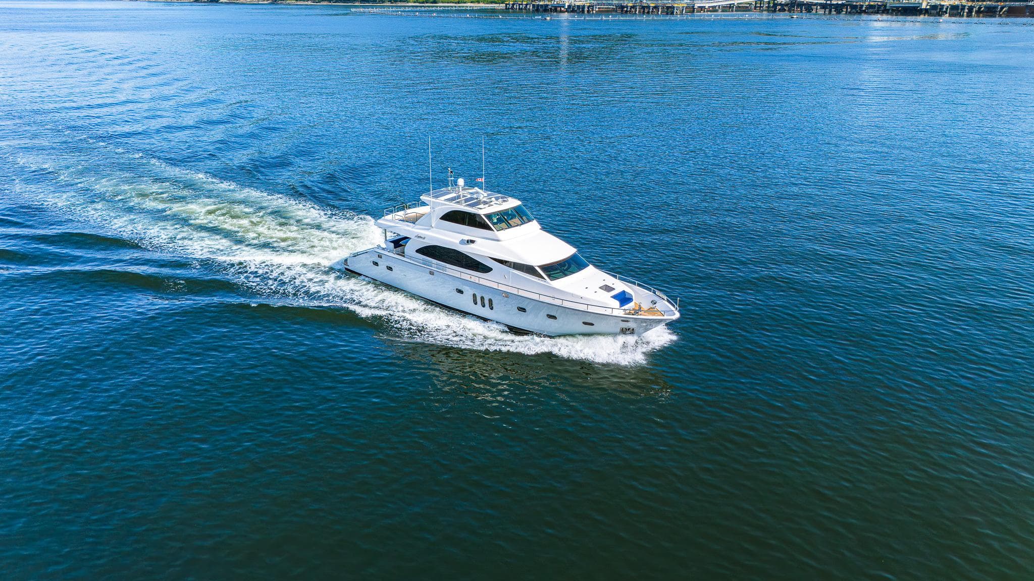 Luxurious 2007 Mystica Skylounge yacht cruising on open blue water.