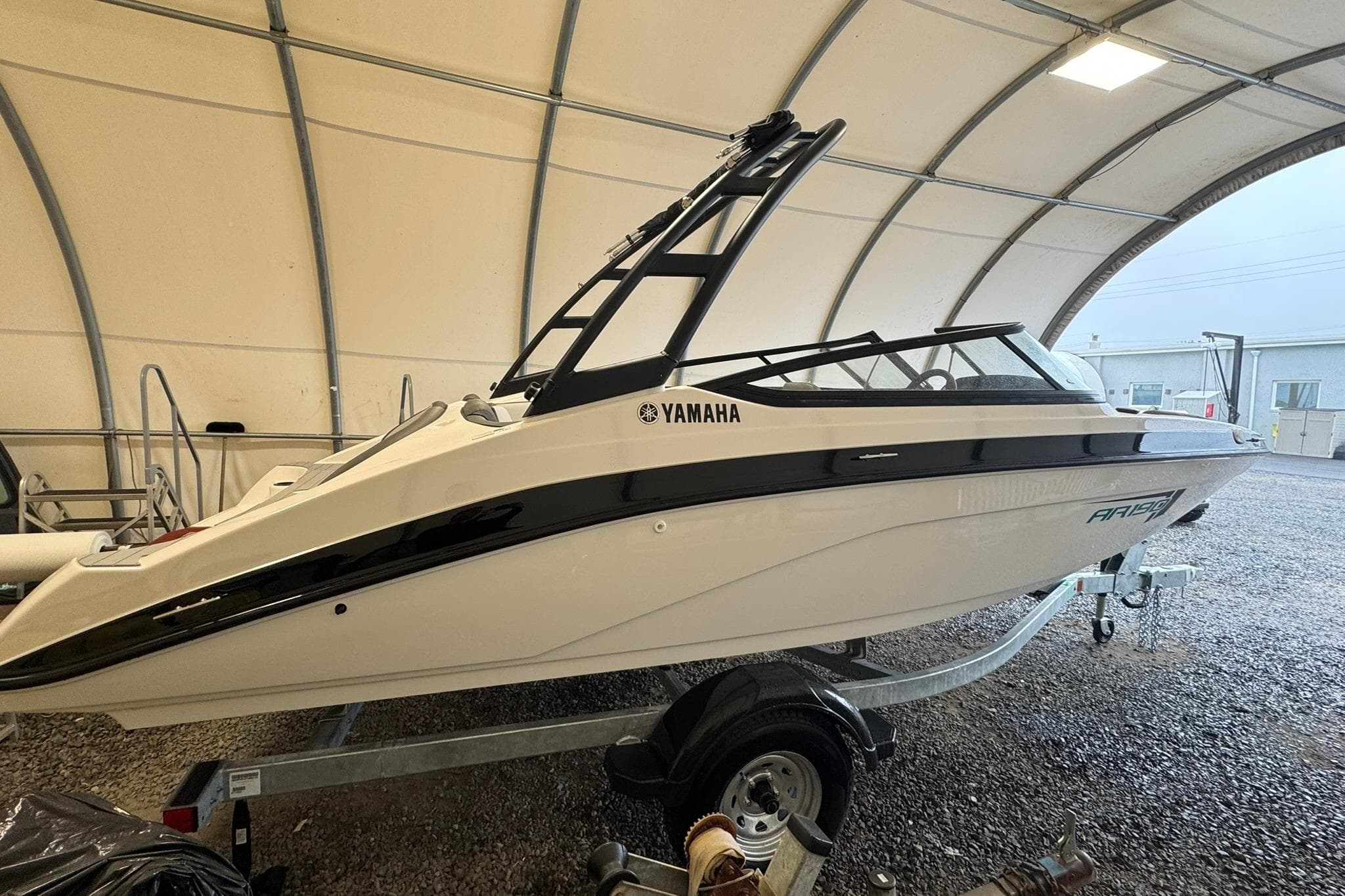 2026 Yamaha AR190 boat in a covered storage area, side view.
