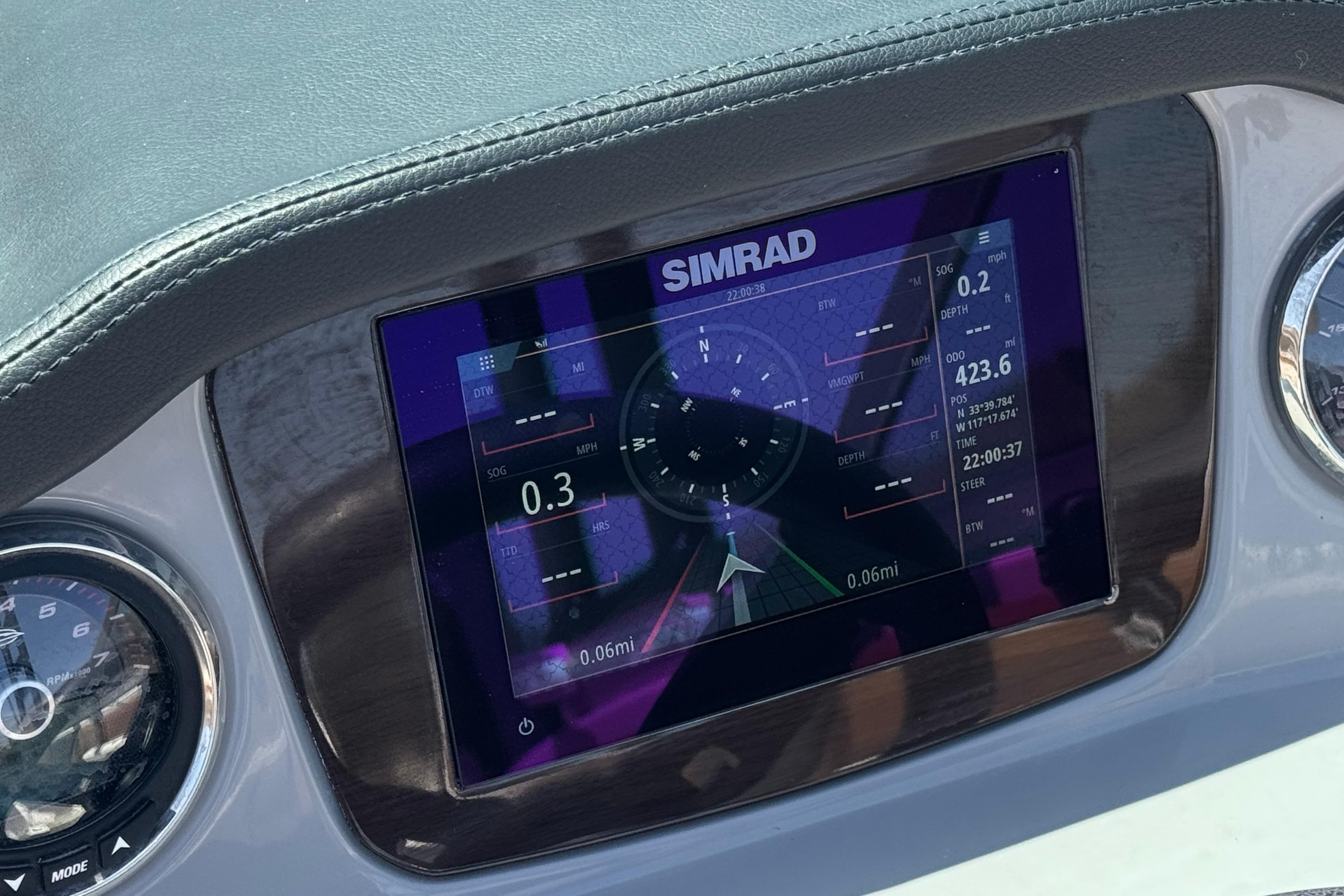 Dashboard of 2023 Chaparral 23 SSi boat featuring Simrad navigation display.