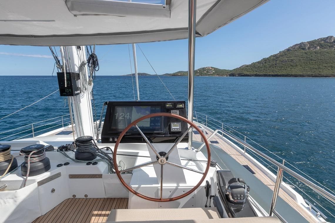 2024 Fountaine Pajot Alegria 67 Catamaran helm with ocean view and navigation equipment.