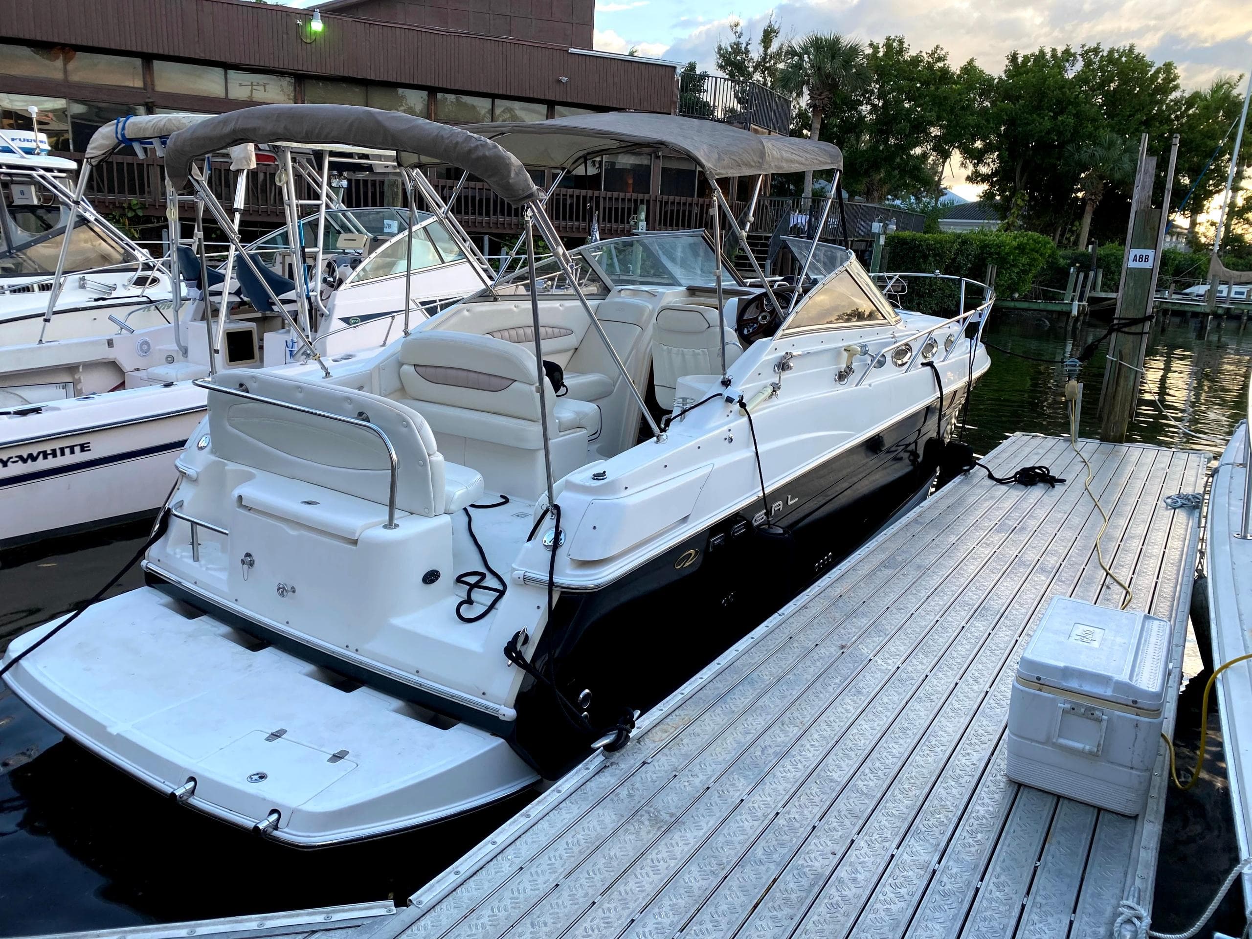 2004 Regal 2760 Commodore boat docked at marina, surrounded by other vessels.