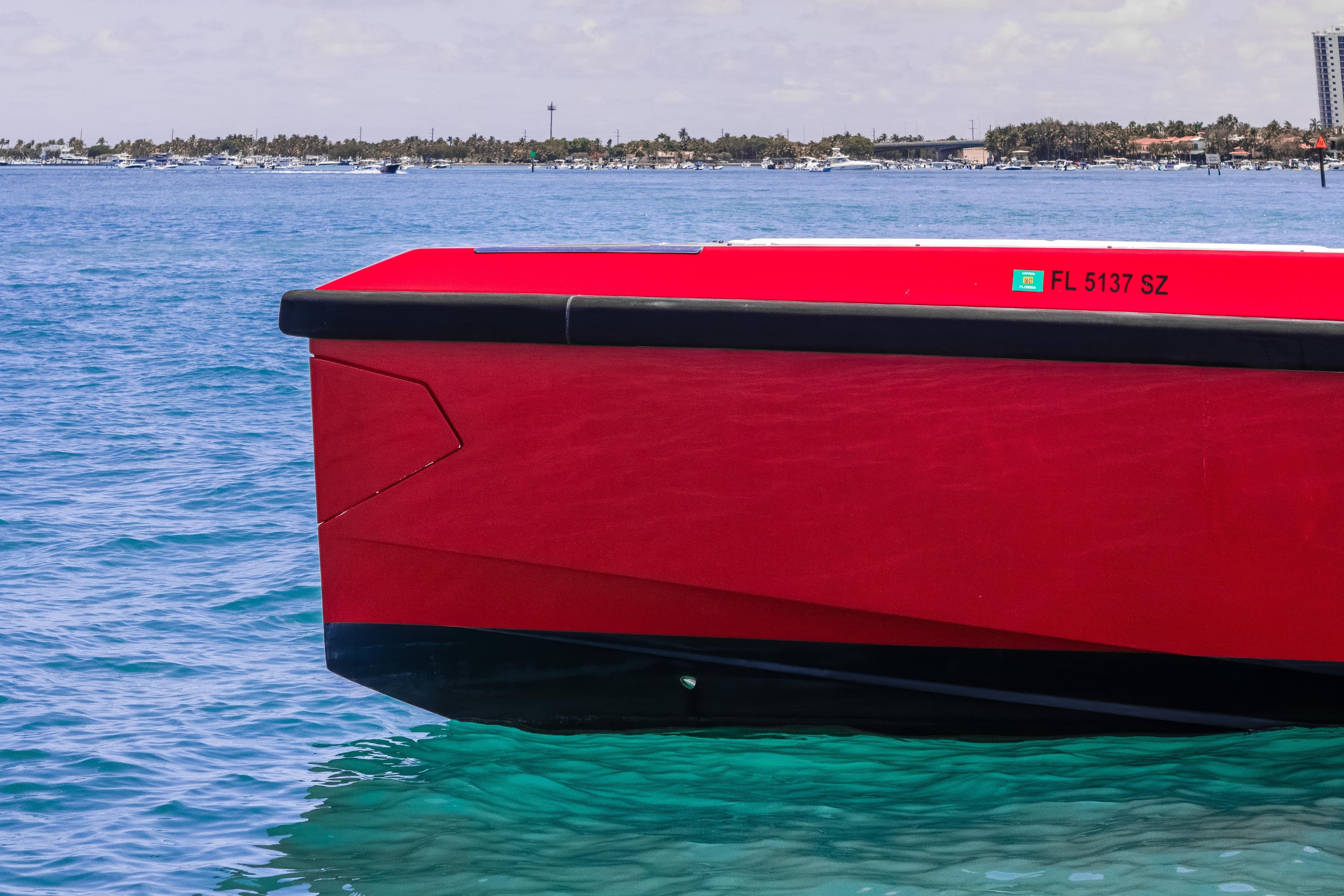 Red Wally 48 boat on clear blue water, 2021 model, side view.