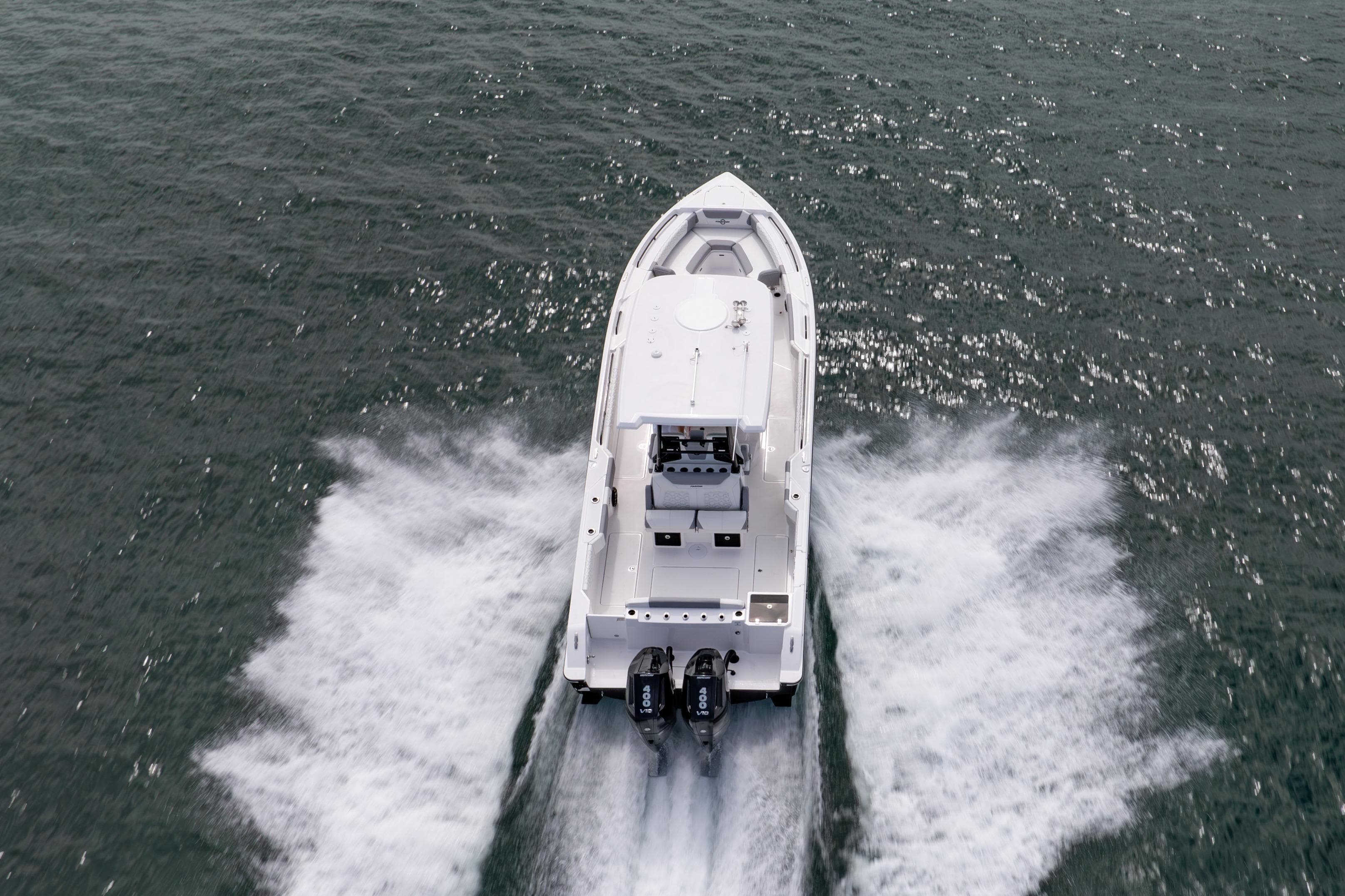 2025 Fountain 32 NX boat cruising on open water, rear view.