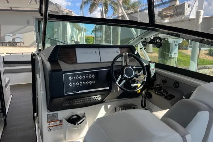 2023 Four Winns H350 OB boat cockpit with modern steering and control panel.