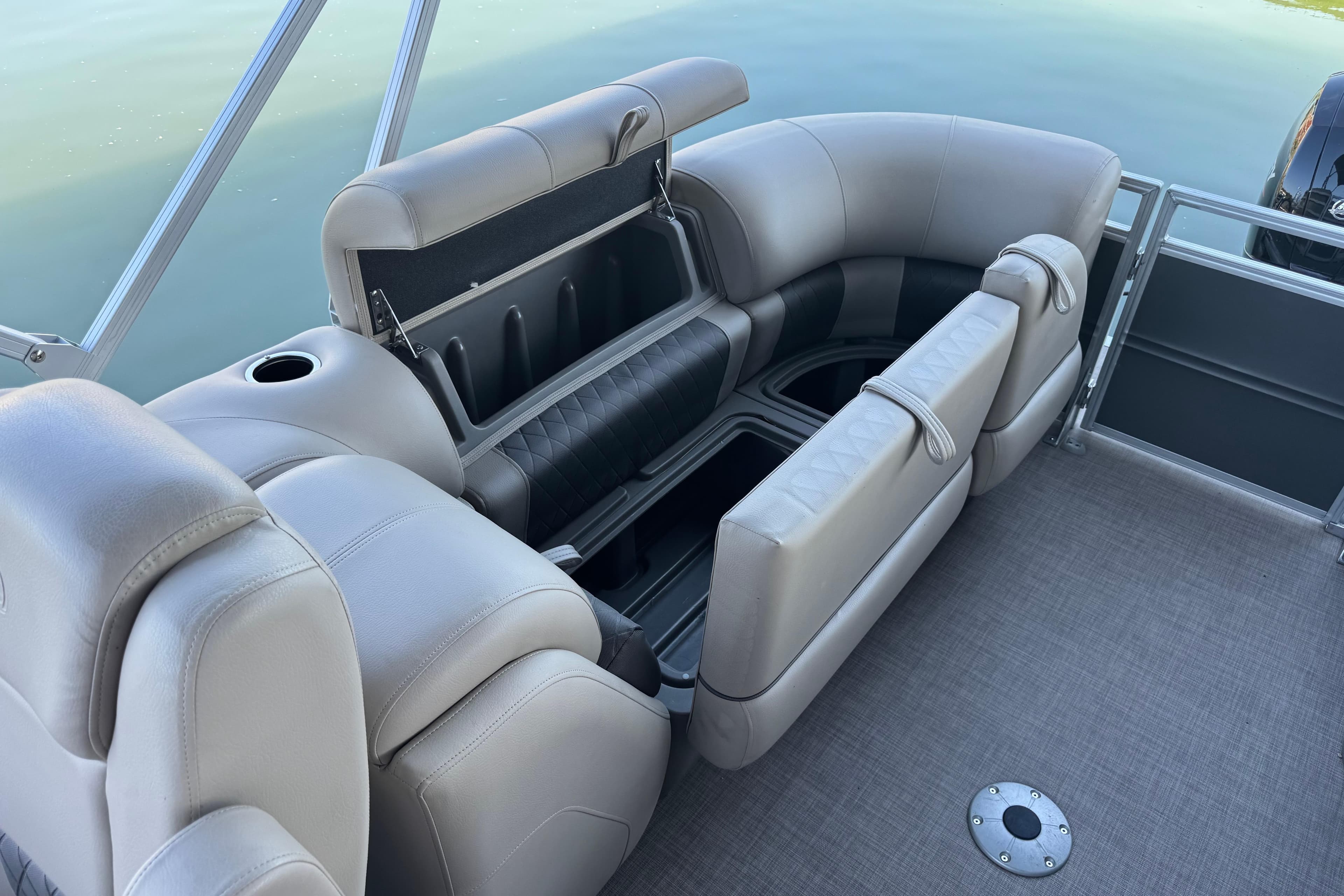 2024 Sun Tracker Party Barge 24 DLX interior seating with storage compartments.