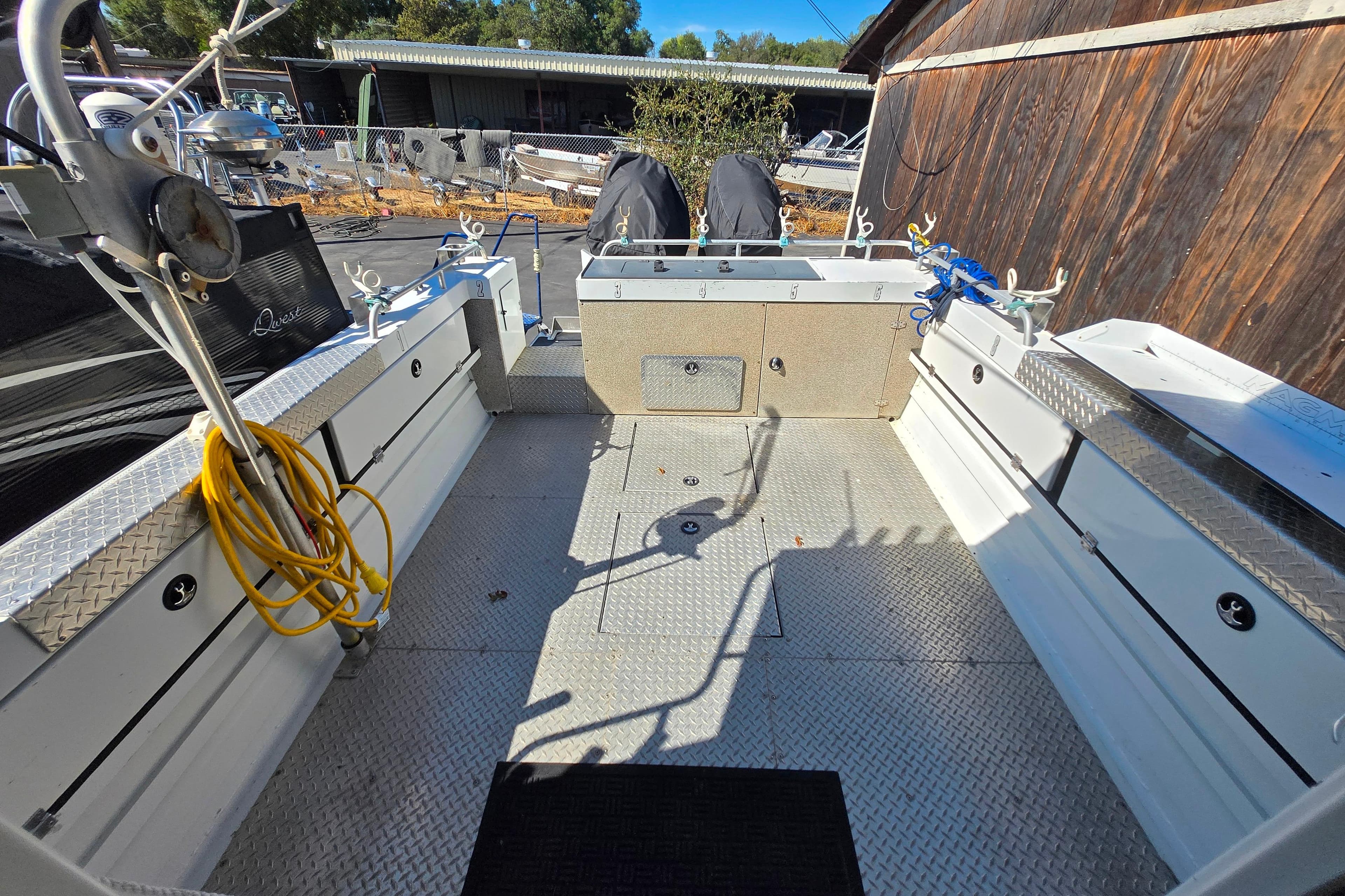 2020 Raider 250 Sea Raider boat interior with fishing equipment and storage compartments.